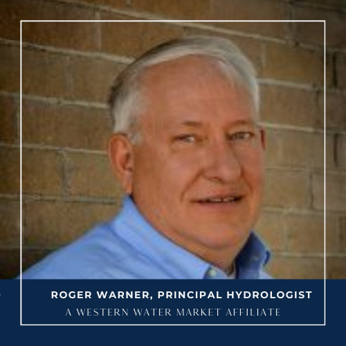 Man wearing a blue shirt and white hair smiling