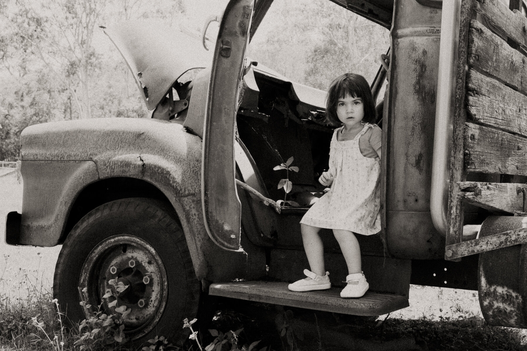 little girl sitting in an old rusty truck Samford Brisbane 