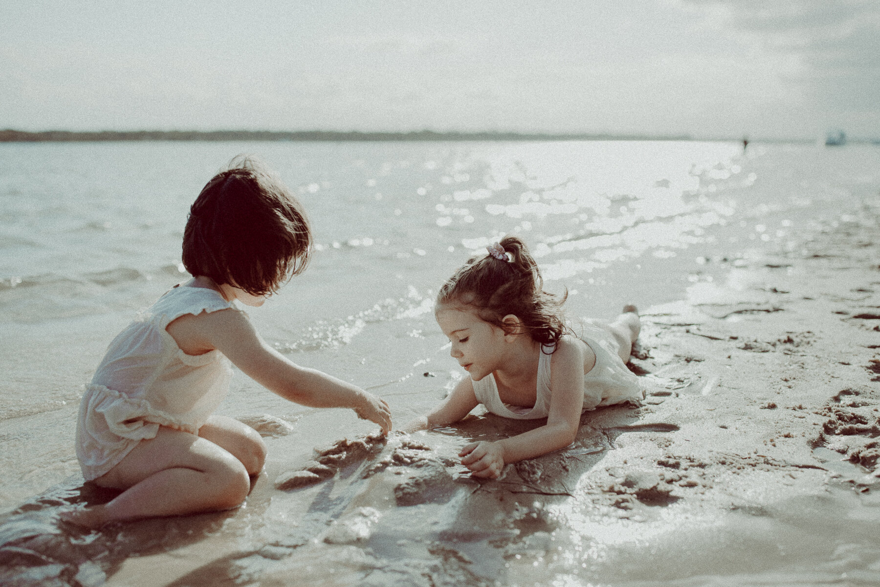 Sylvan Beach Bribie Island two sisters playing in sand