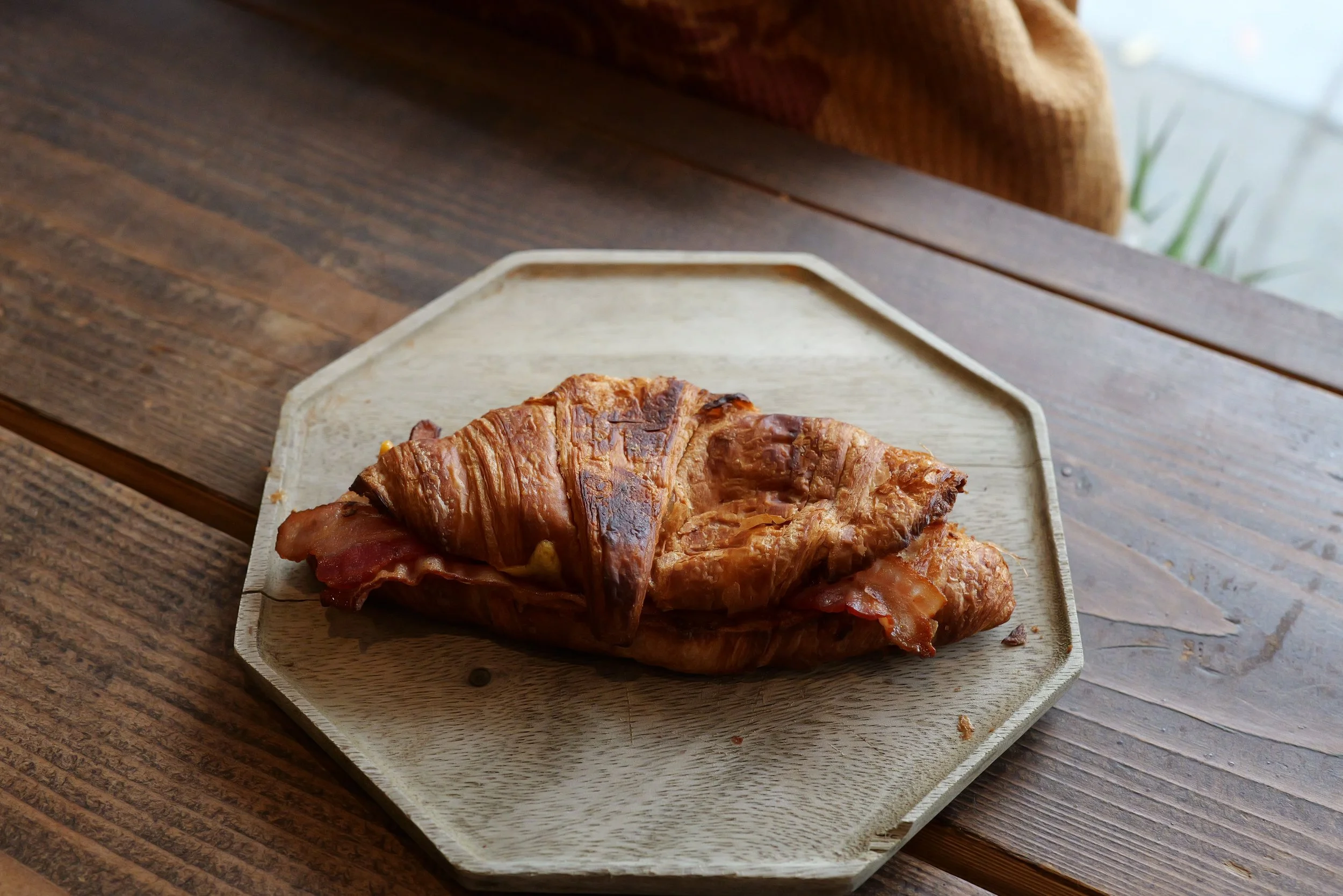 Our bacon cheddar coissant sandwich