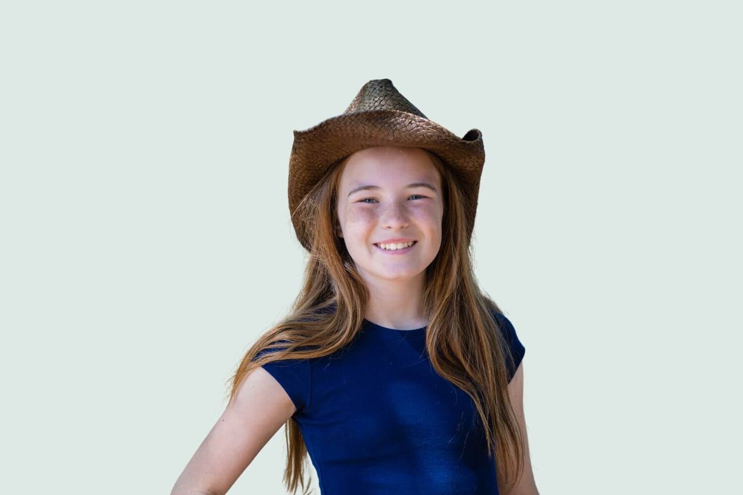 farm girl with long hair wearing a western hat and t-shirt