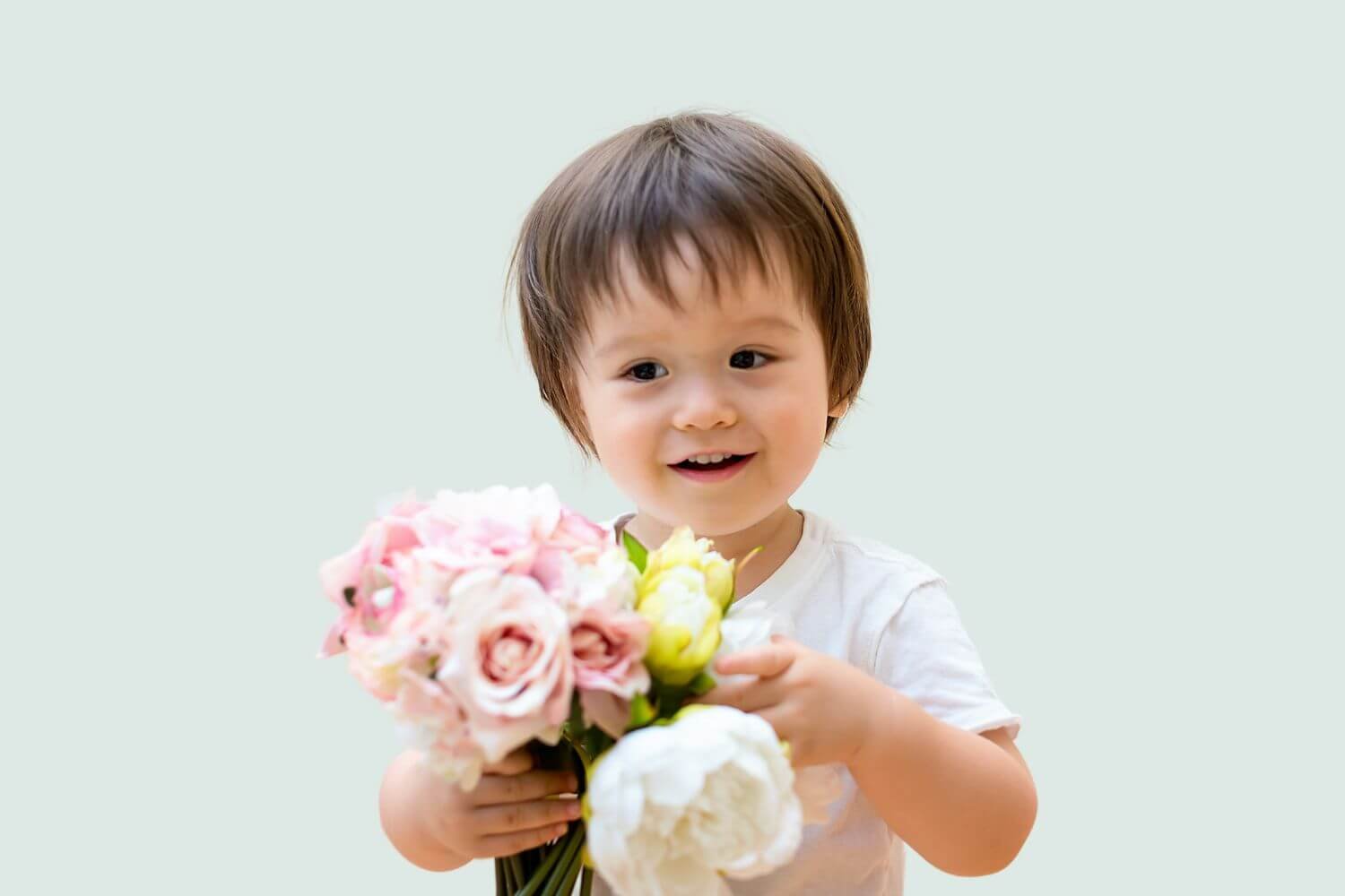 little boy holding flower bouquet