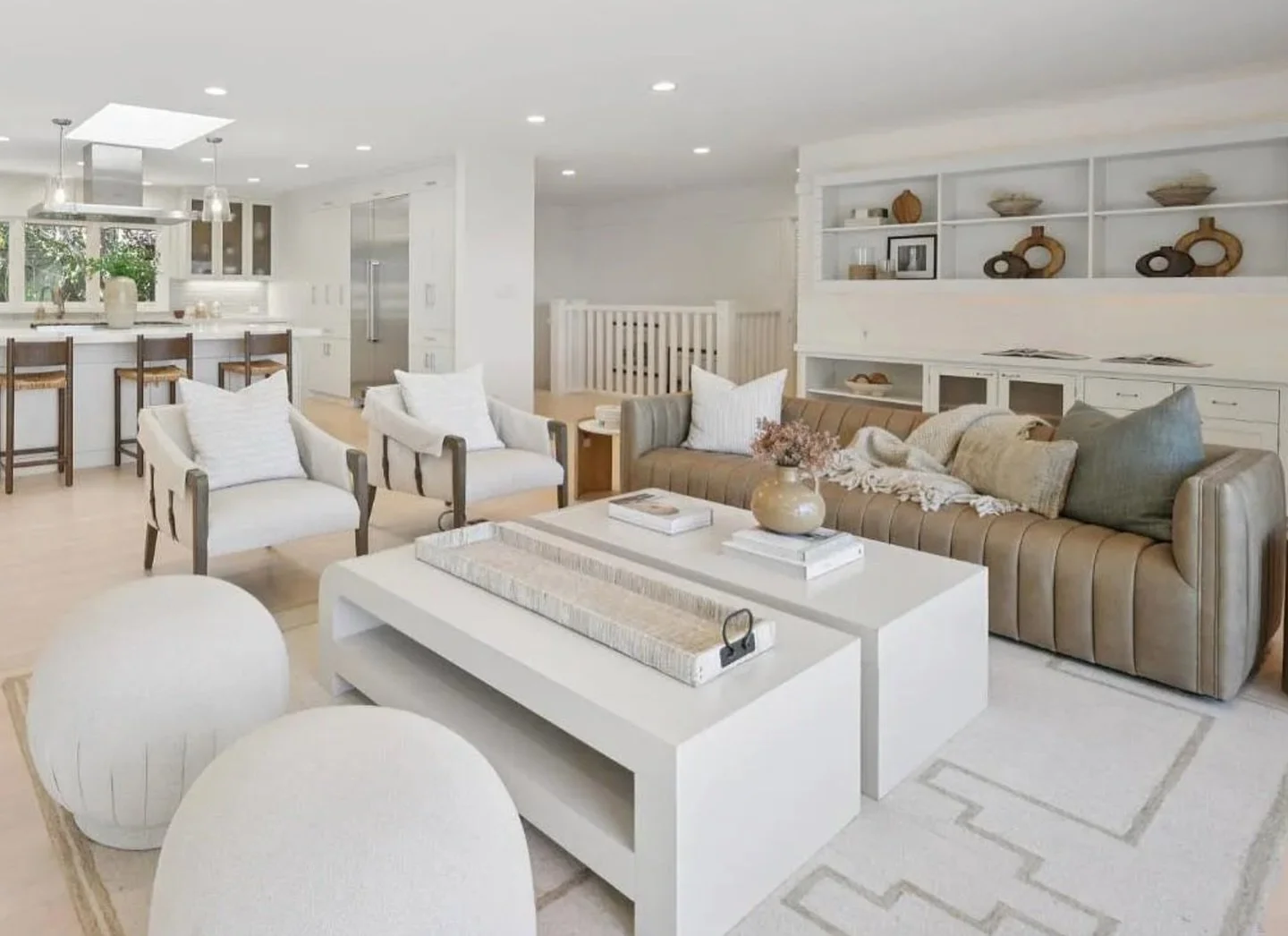 Light, bright, and effortlessly livable.

This open-concept space is all about softness and flow &mdash; from the clean white kitchen to the layered living area anchored by warm neutrals and subtle texture. Sculptural seating, a tonal rug, and a mix 
