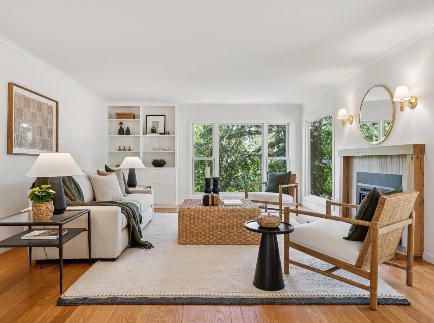 Classic Pezzolo style, right down to the details.

Warm neutrals, natural woven textures, black accents, and just enough brass to catch the light. The built-ins styled with intention, the layered rugs grounding the space, the greenery pulling the out