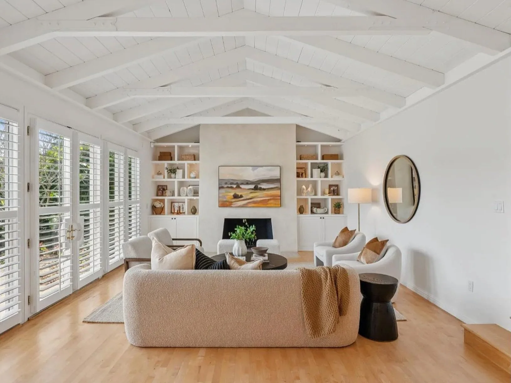 This waterfront gem in one of Marin&rsquo;s most coveted enclaves gave us everything to work with. Soaring white beamed ceilings, walls of light, built-ins flanking a fireplace that anchors the entire room, and just outside &mdash; sailboats on the w
