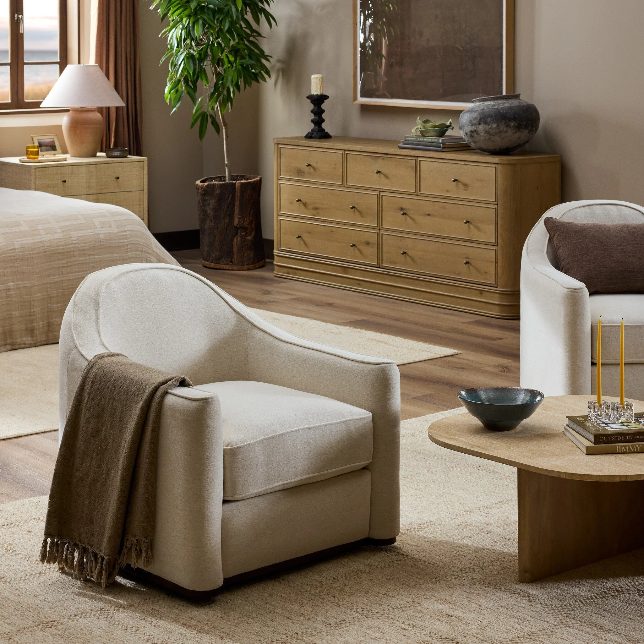 Minimalist bedroom with textured plaster walls and upholstered bed with leather straps.