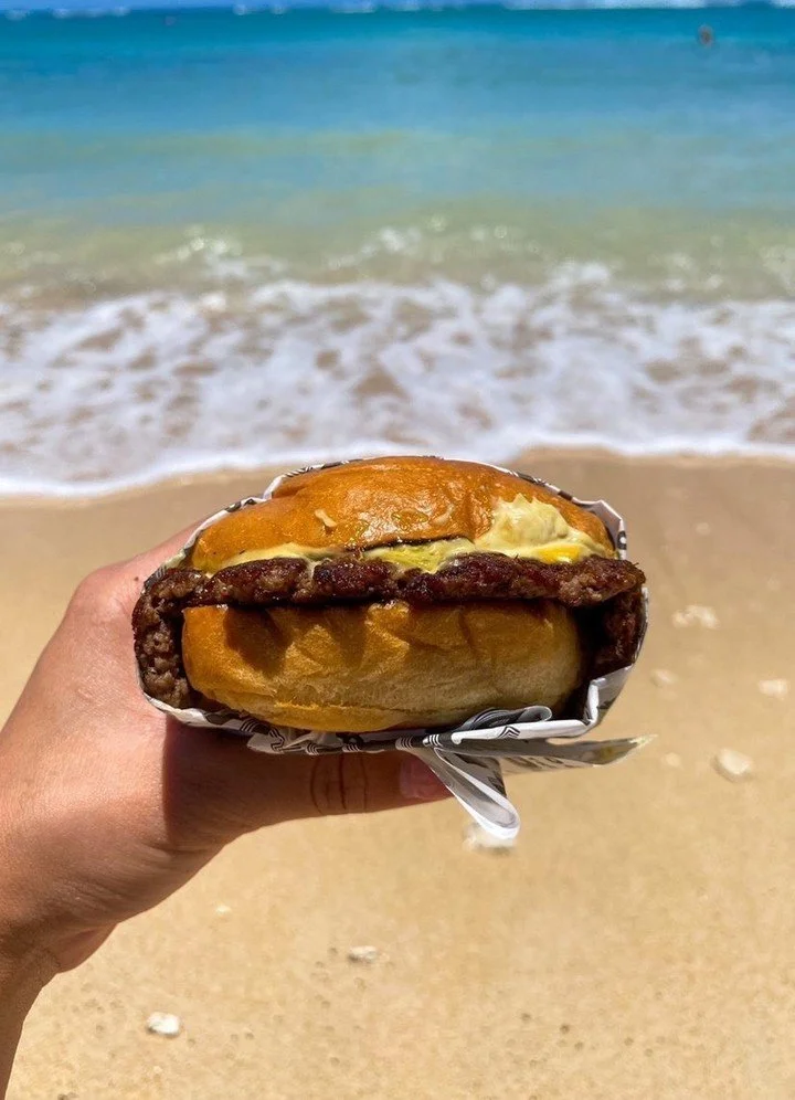 Burgers hit different by the water. Pull up to our Waikiki Food Truck just a block from the ocean on Lemon Rd.