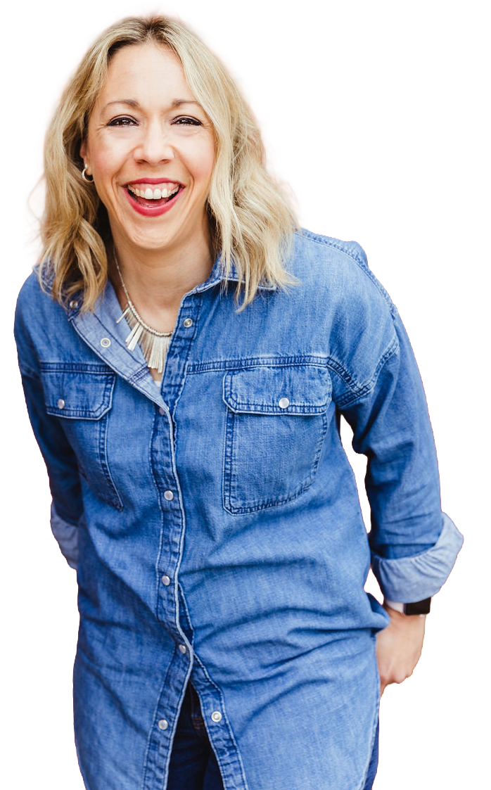 A woman with blonde, curly hair smiling and wearing a denim shirt.