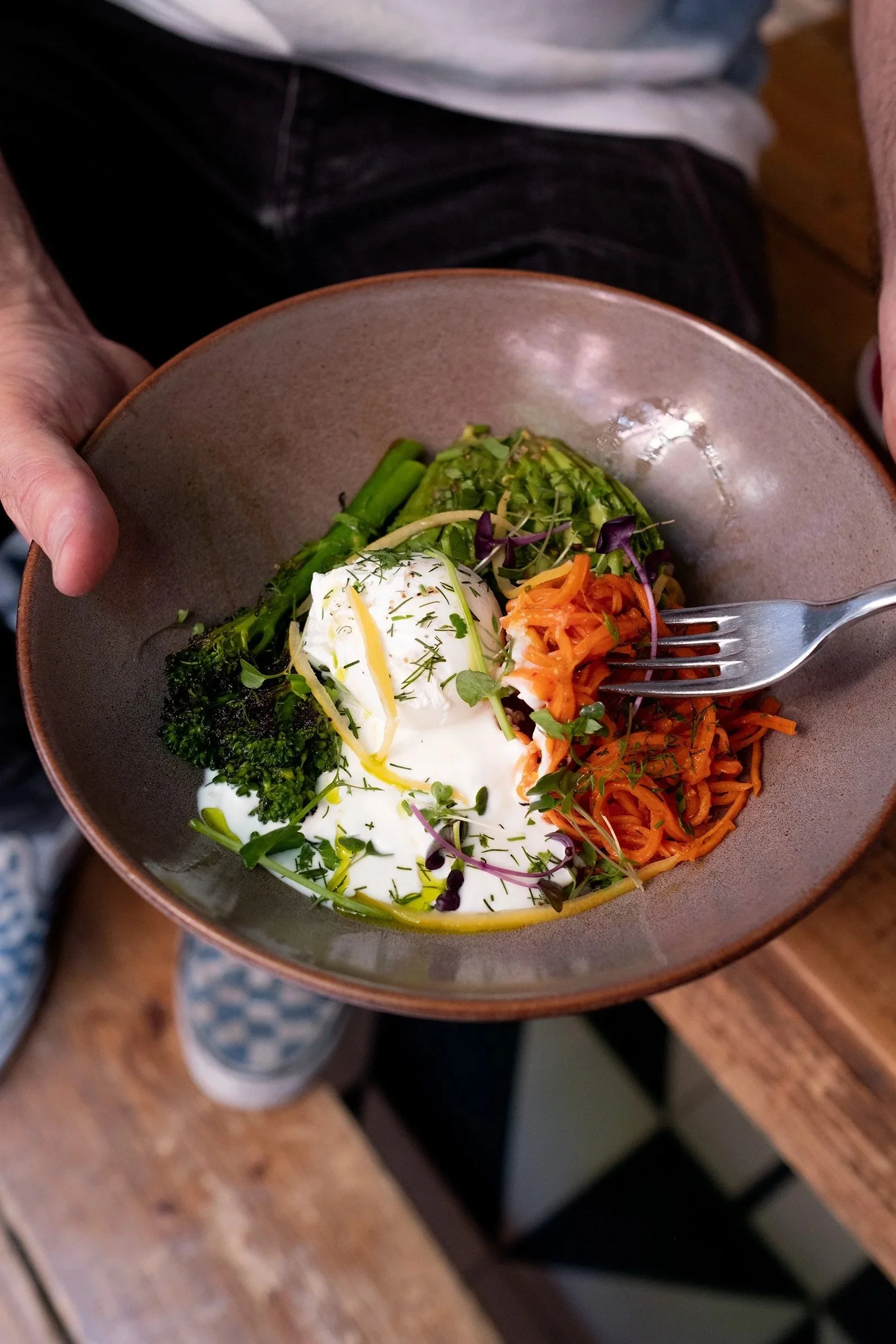 Our healthy breakfast salad bowl with eggs greens and grains