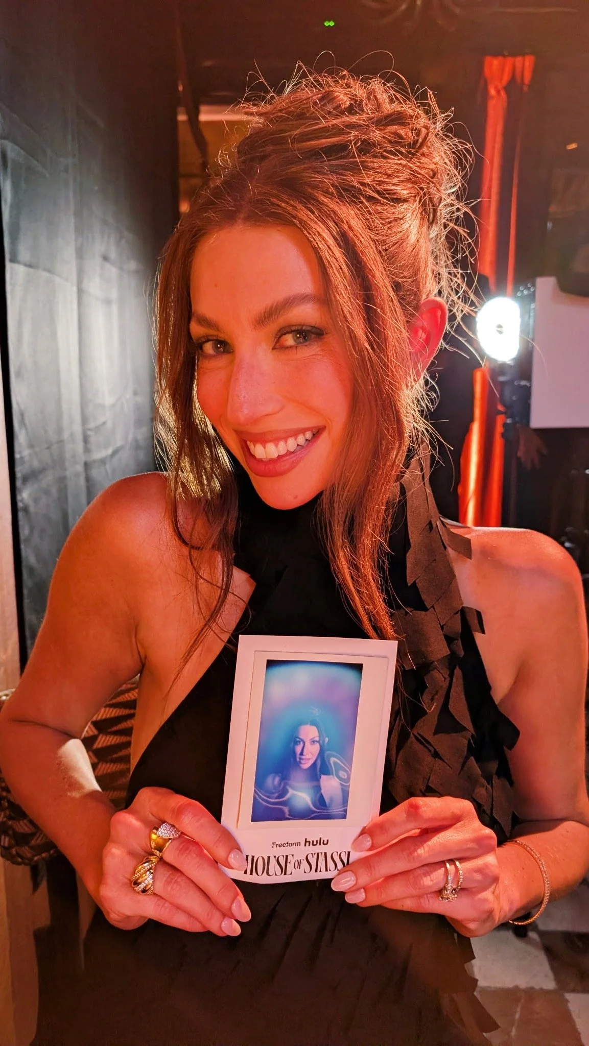 Stassi Schroeder holding her blue aura portrait at the House of Stassi launch event