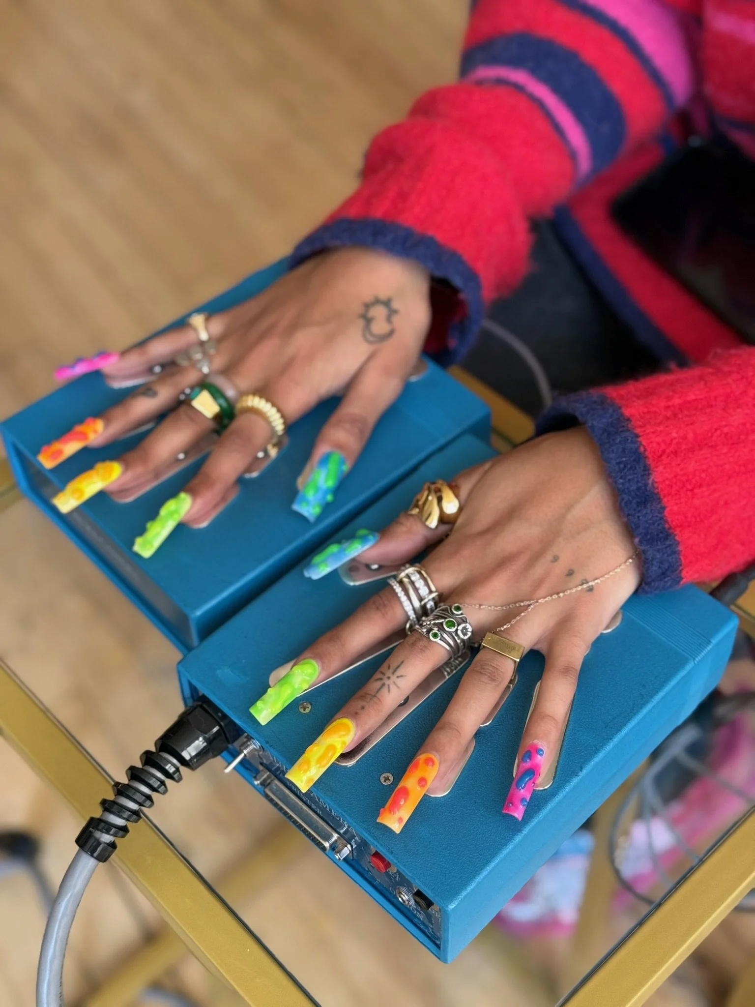 Guest's hands on aura camera biofeedback plates at NYC brand event by Inner Light Aura