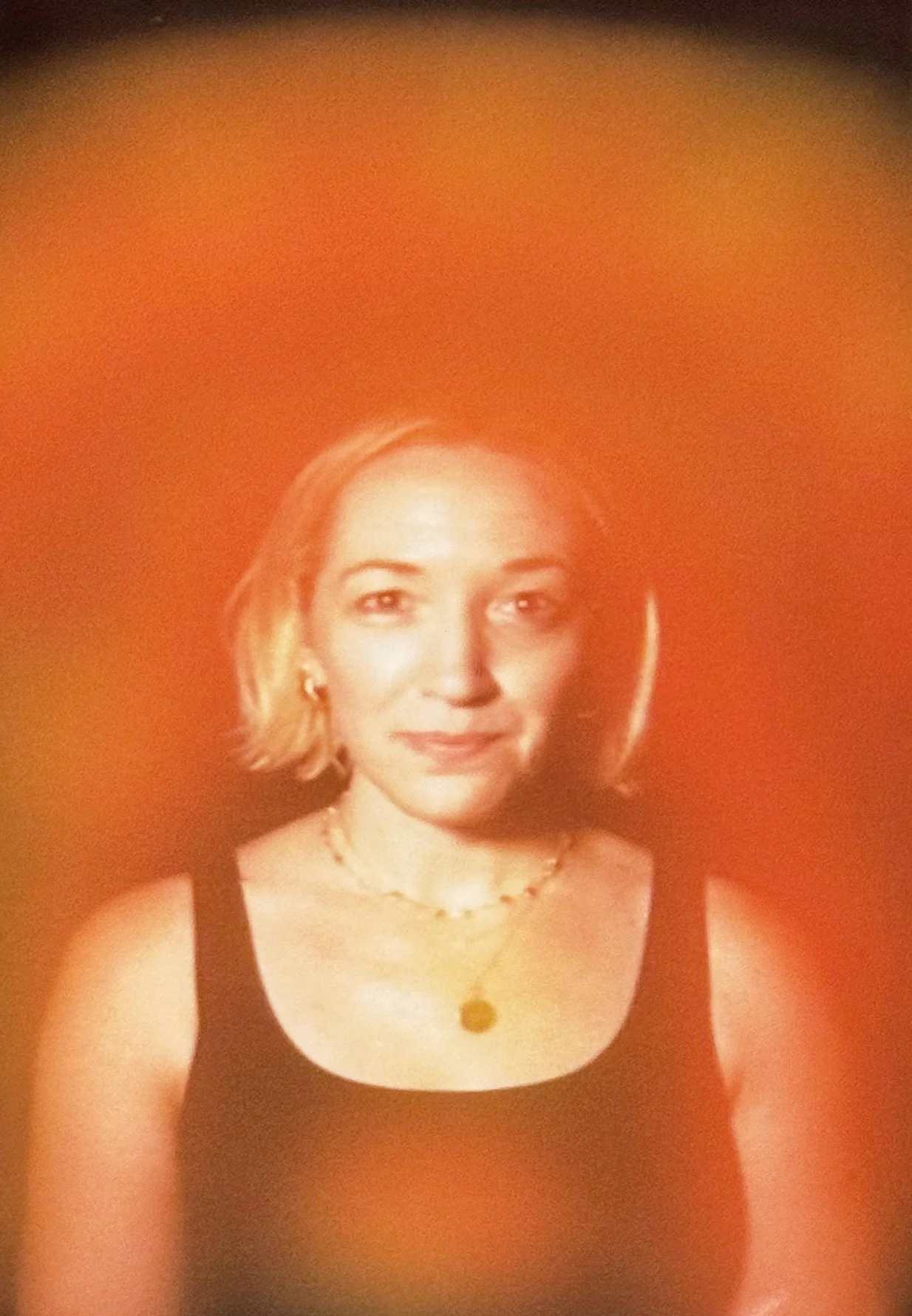 Aura portrait showing a bright orange aura swirling around her body.