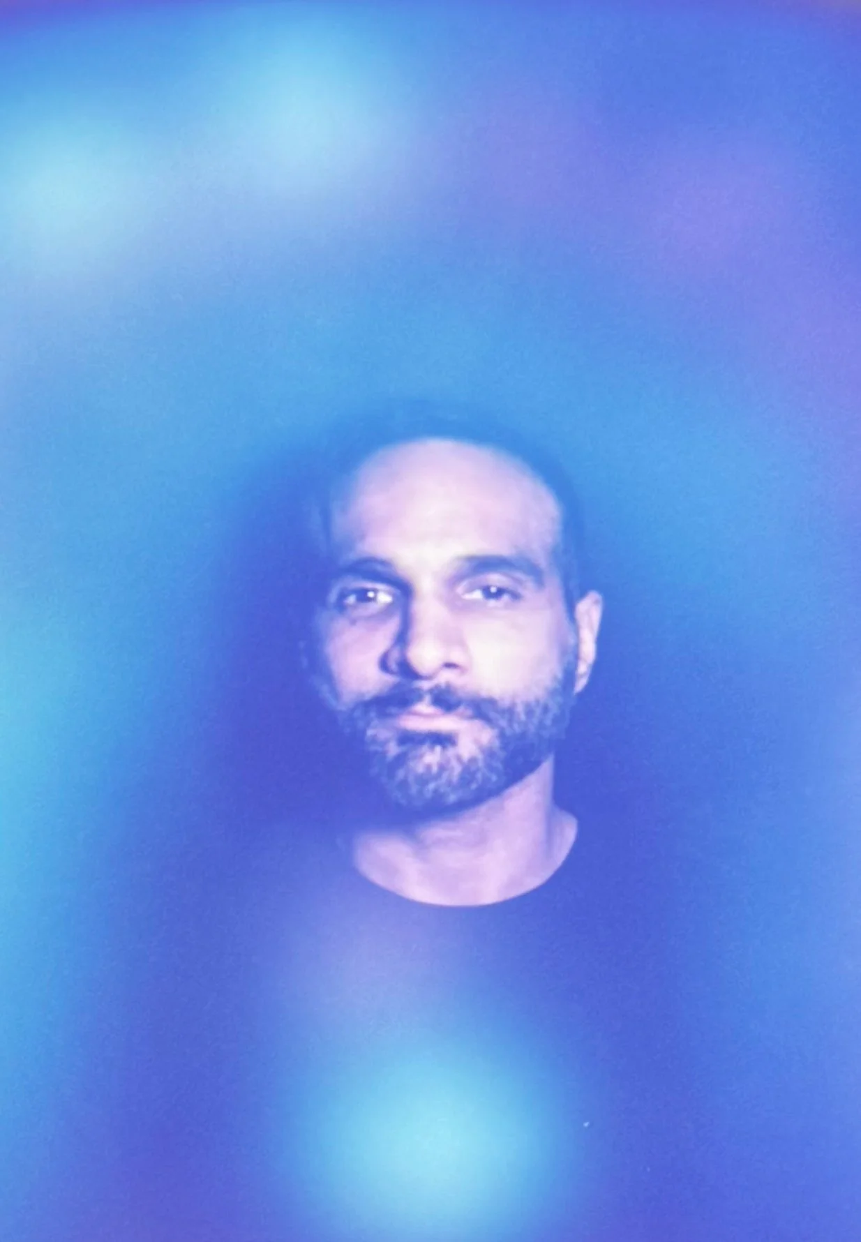 Indigo aura portrait with a deep blue-violet field around the man.