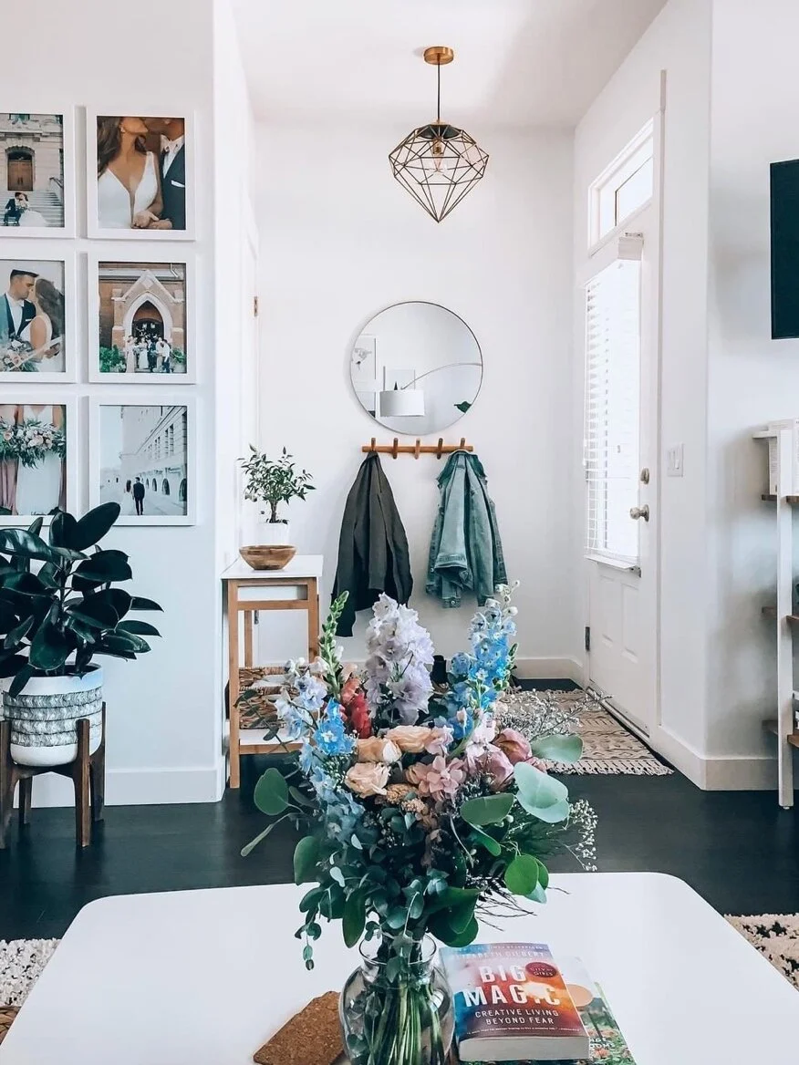 Fresh flowers and family photos personalize this space.
