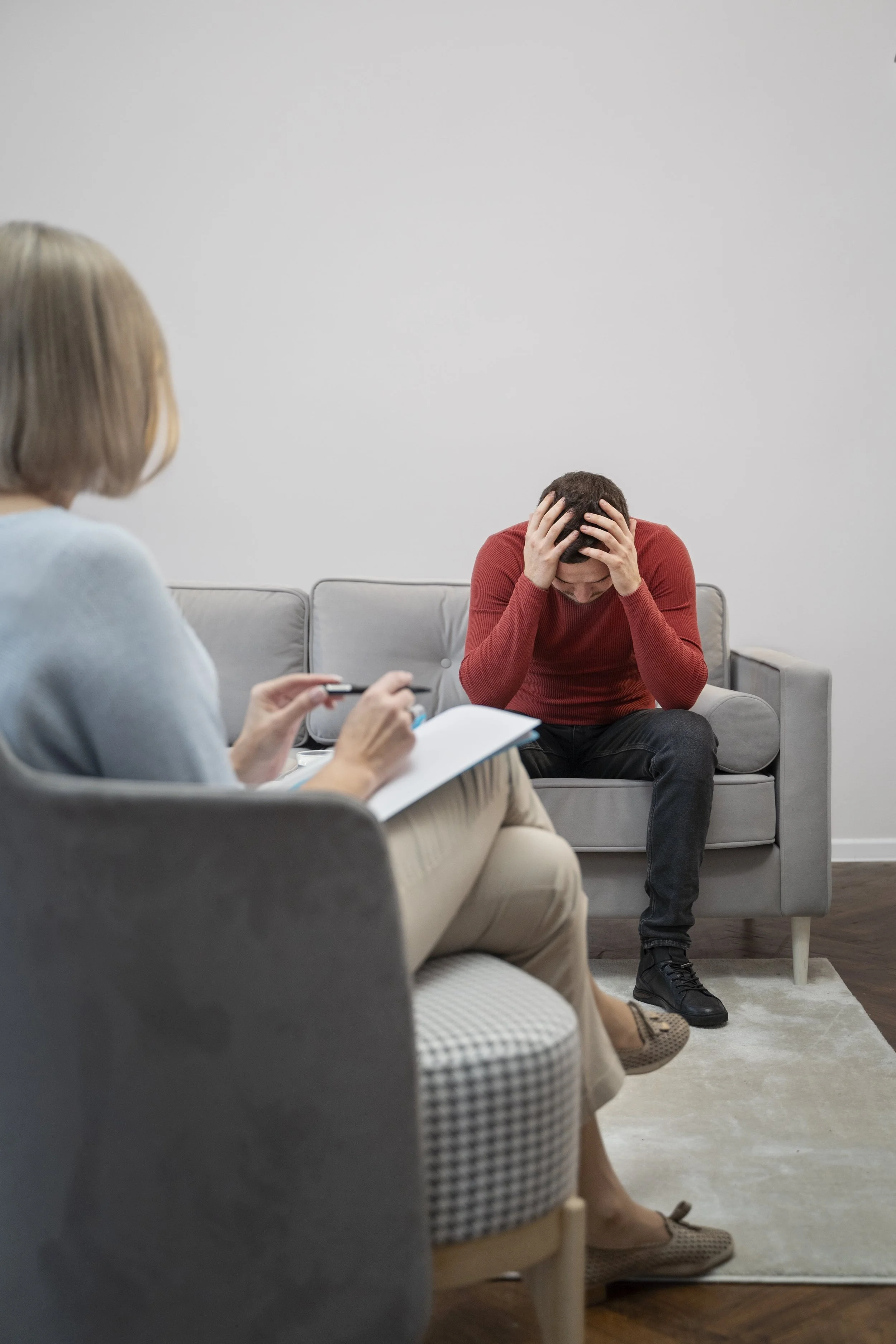 Man in therapy session showing signs of emotional distress during OCD treatment