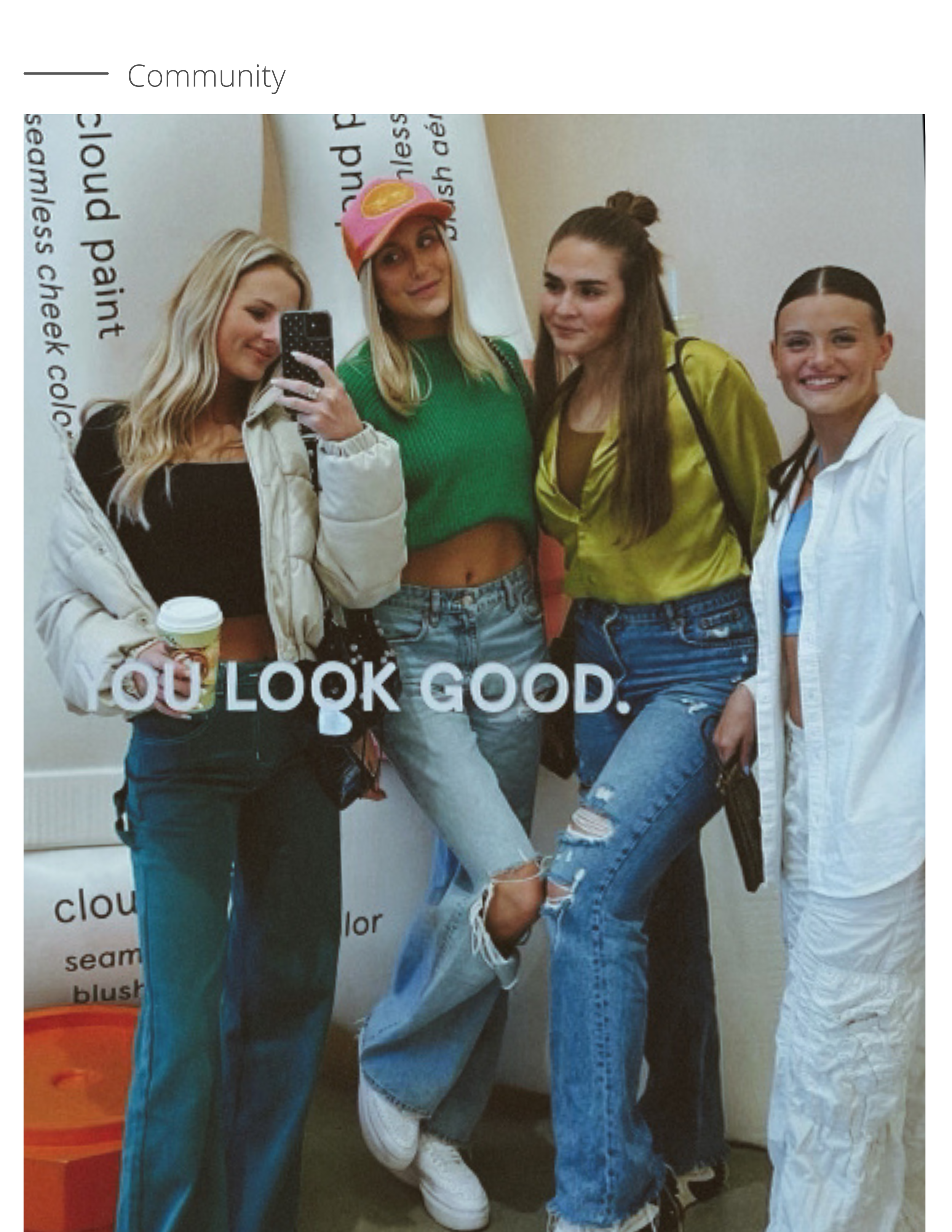 Image of four girls posing for a mirror selfie.