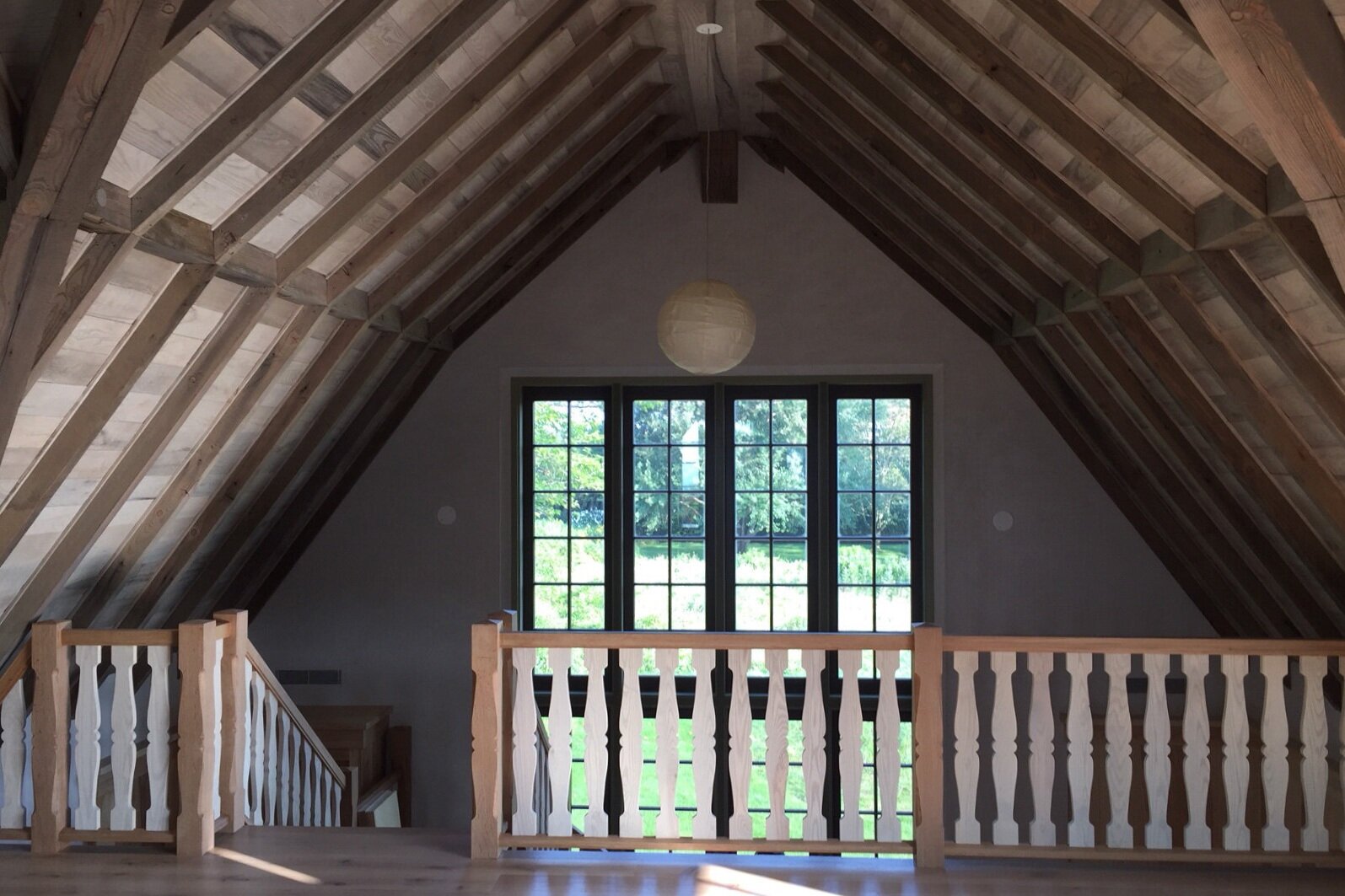 interior | view of staircase in face of double story window