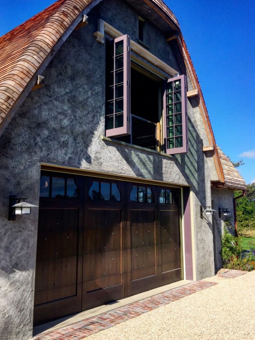 exterior | one of two garage doors with second floor bi-fold window open