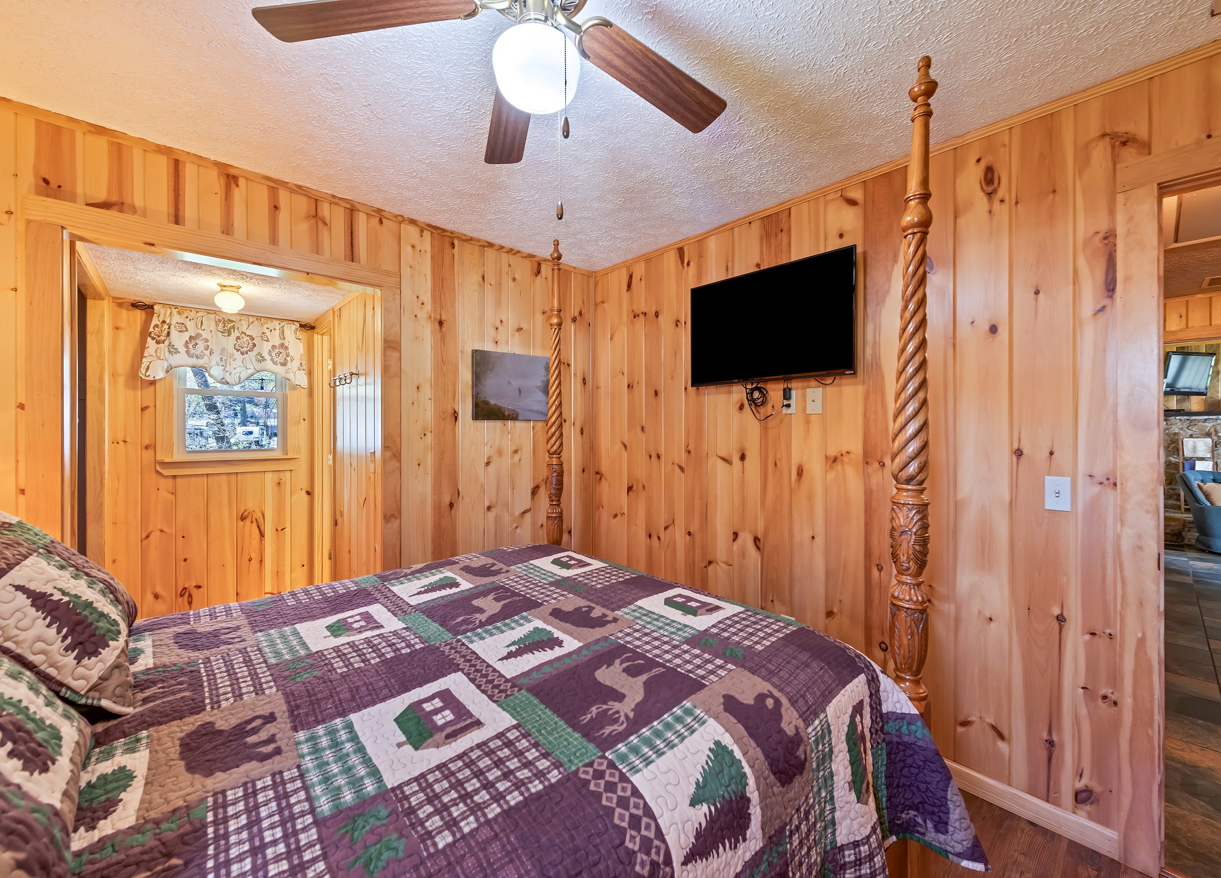 Primary bedroom with dresser, 2 nightstands and TV.