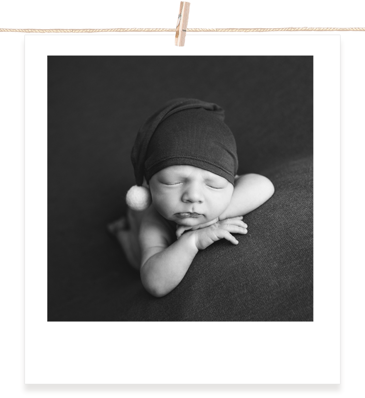Head on hands newborn pose.png