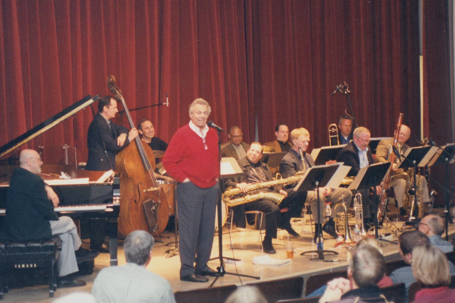 Mort Sahl introducing the evening.The ensemble (L to R): Milcho Leviev, Darek Oles, Joe La Barbera, Mort Sahl, Bill Roper, Gary Smulyan, Dave Woodley, Bob Summers, Mitch Mocilnikar, John Reilly, Don Shelton