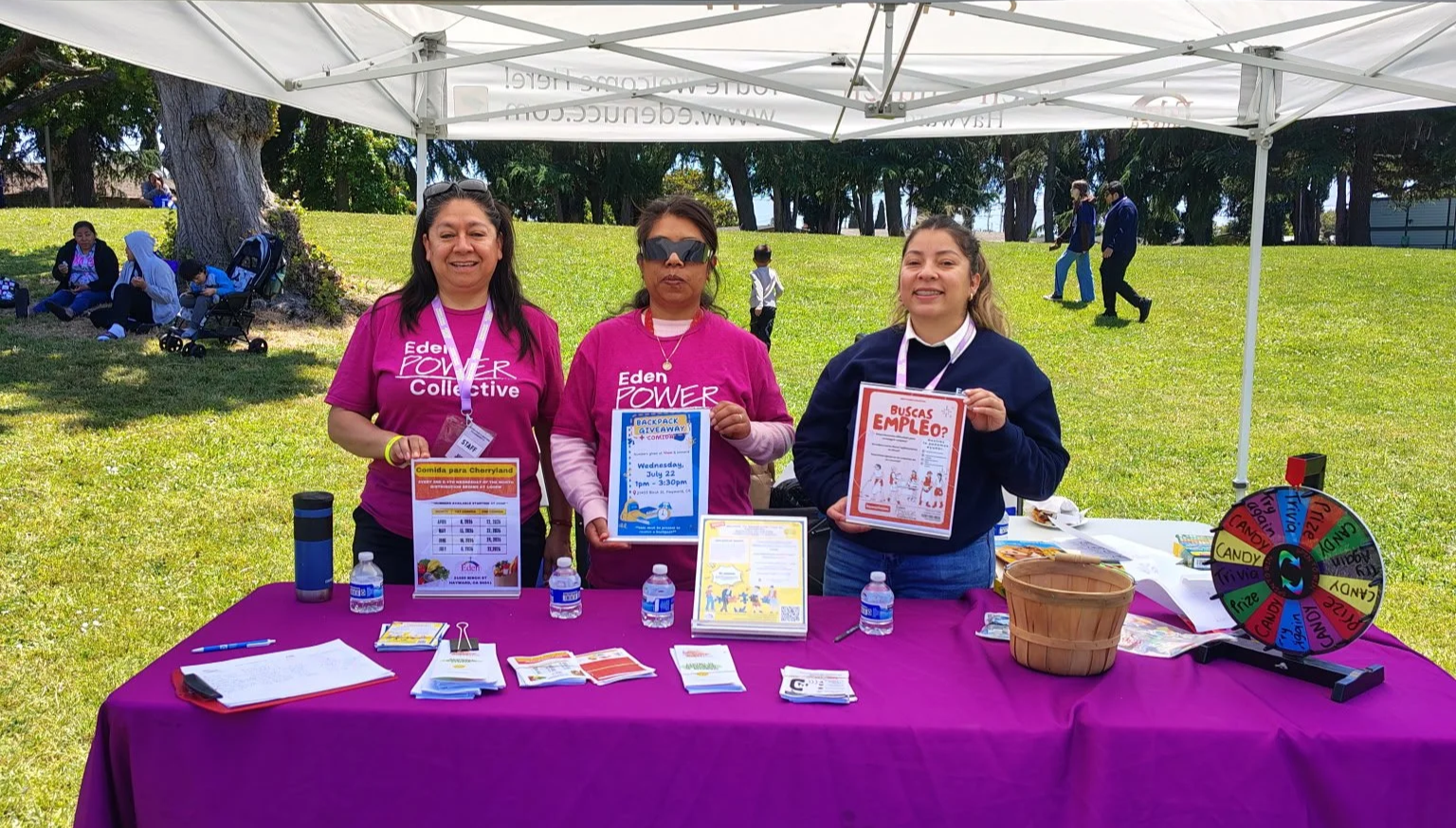 Eden Power Collective team conducting community outreach at a booth