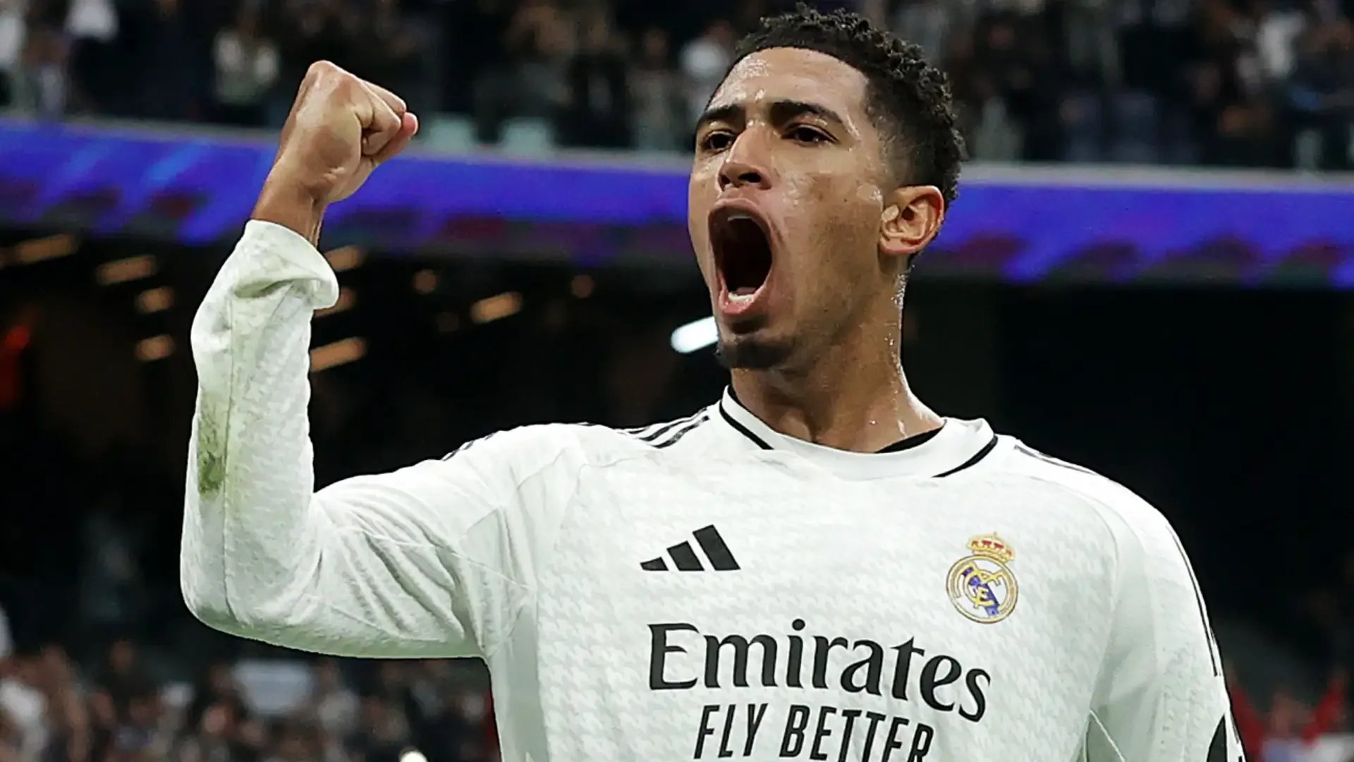 ude Bellingham driving forward with the ball for Real Madrid at the Santiago Bernabéu