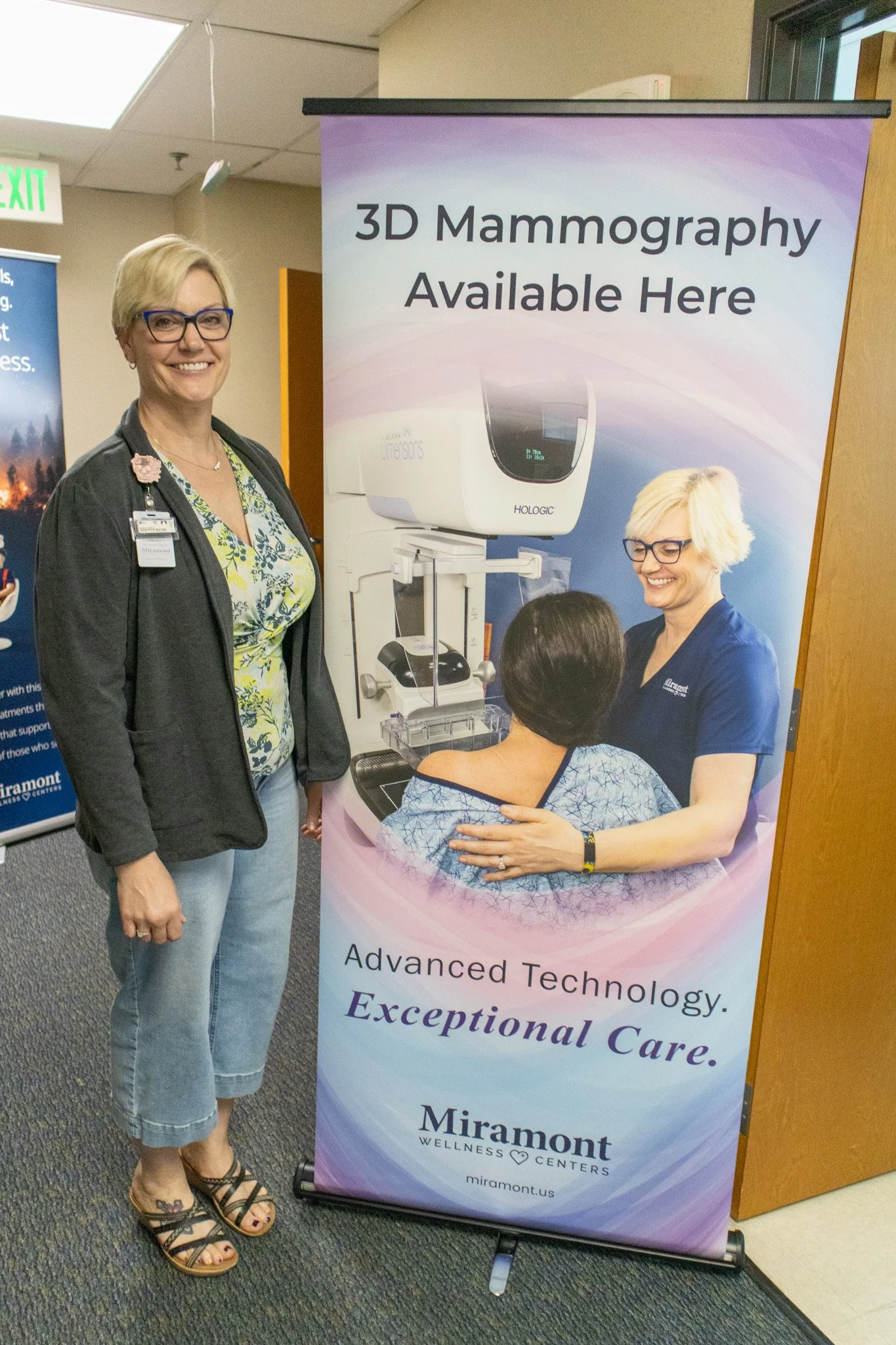 85" vinyl banner featuring a new 3D mammography machine. Imaging Director Sheila proposed the project, drafted an AI concept, and was also featured in the photo on the banner.