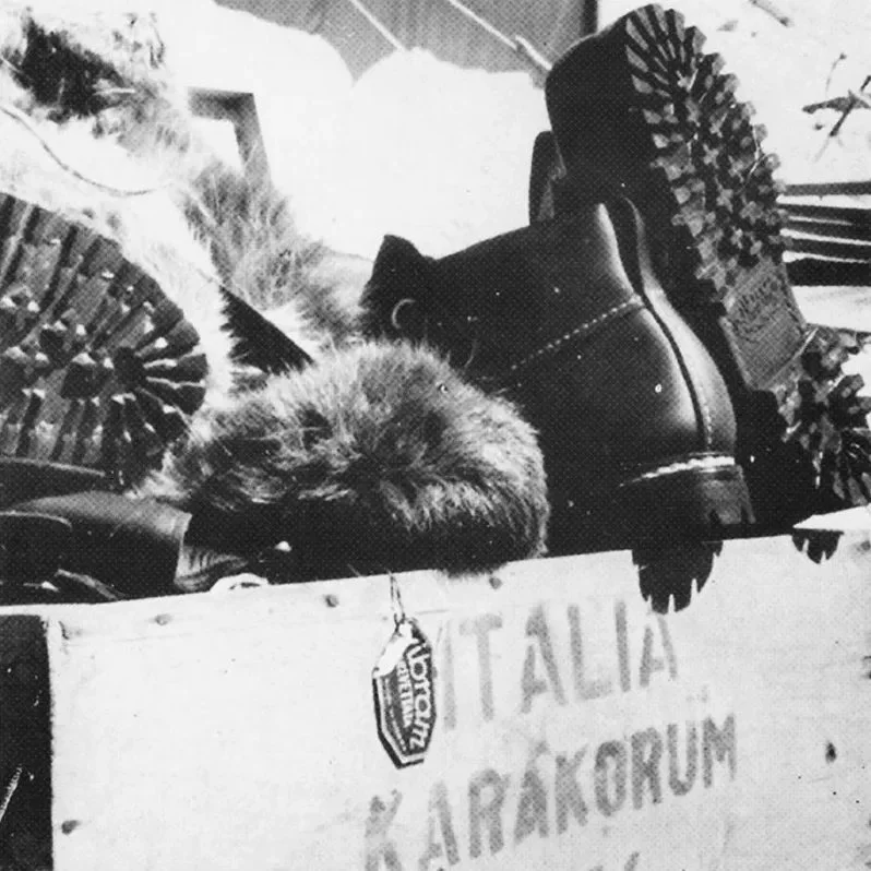 20. Black-and-white photograph of Vibram-soled mountaineering boots resting on a crate labeled Italia Karakorum.jpg