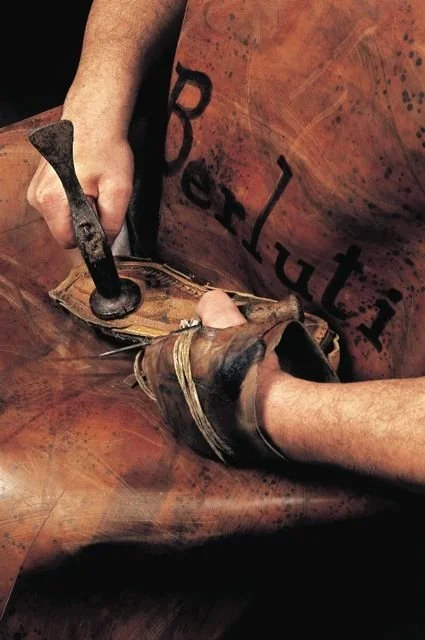 8. Hands shaping and nailing a leather shoe upper on a last using traditional shoemaking tools.jpg