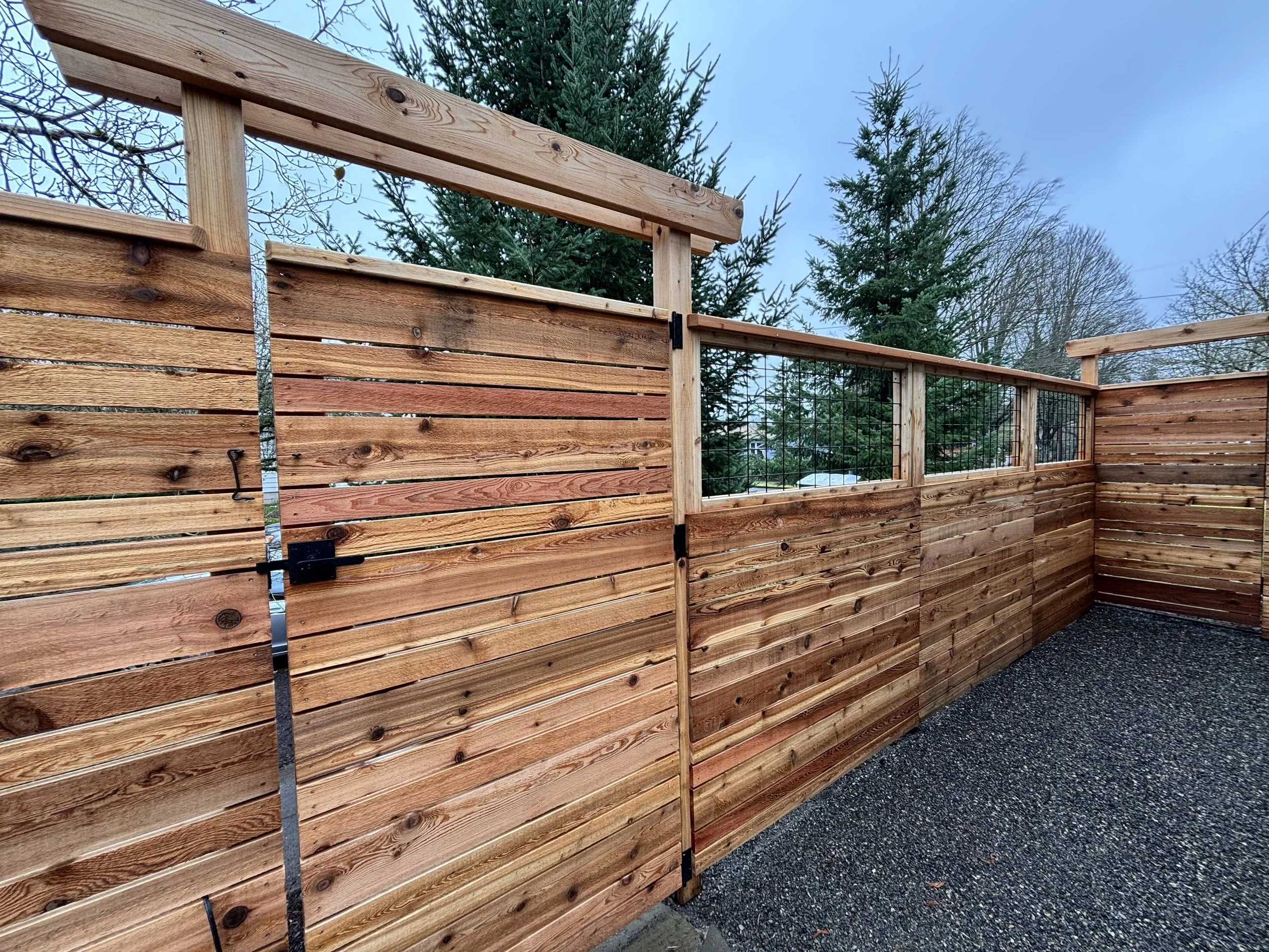 alternating board fence with gate and arbor