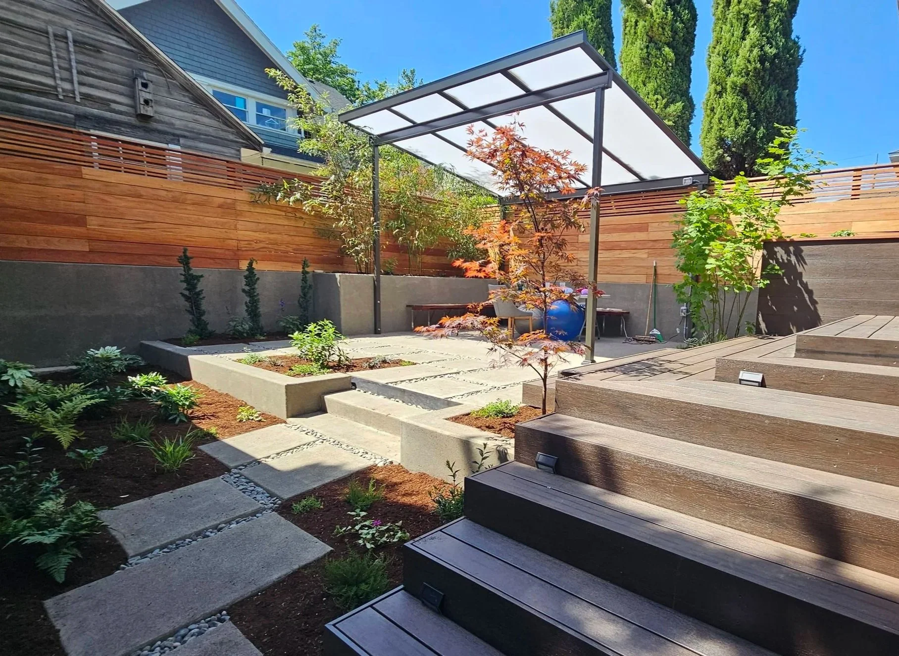 modern small back yard composite deck and concretepatio