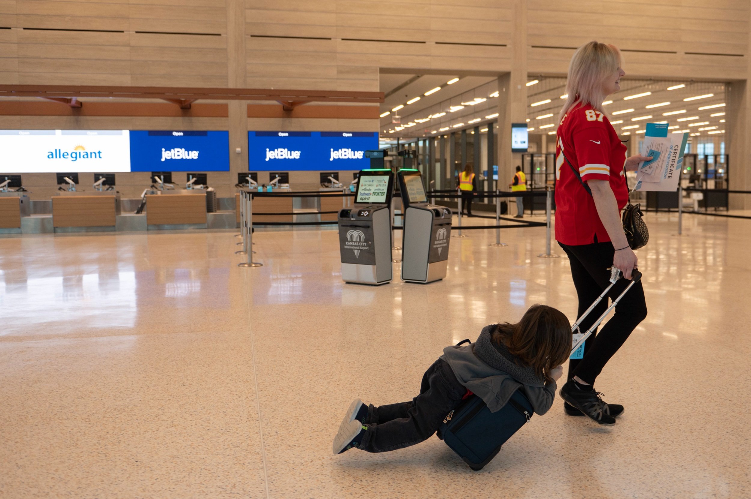  Rachelle Landreth, right, and her four-year-old son Ozzy Nacis, finish a flying a simulation tour at Kansas City International Airport on Tuesday, Feb. 14, 2023. 