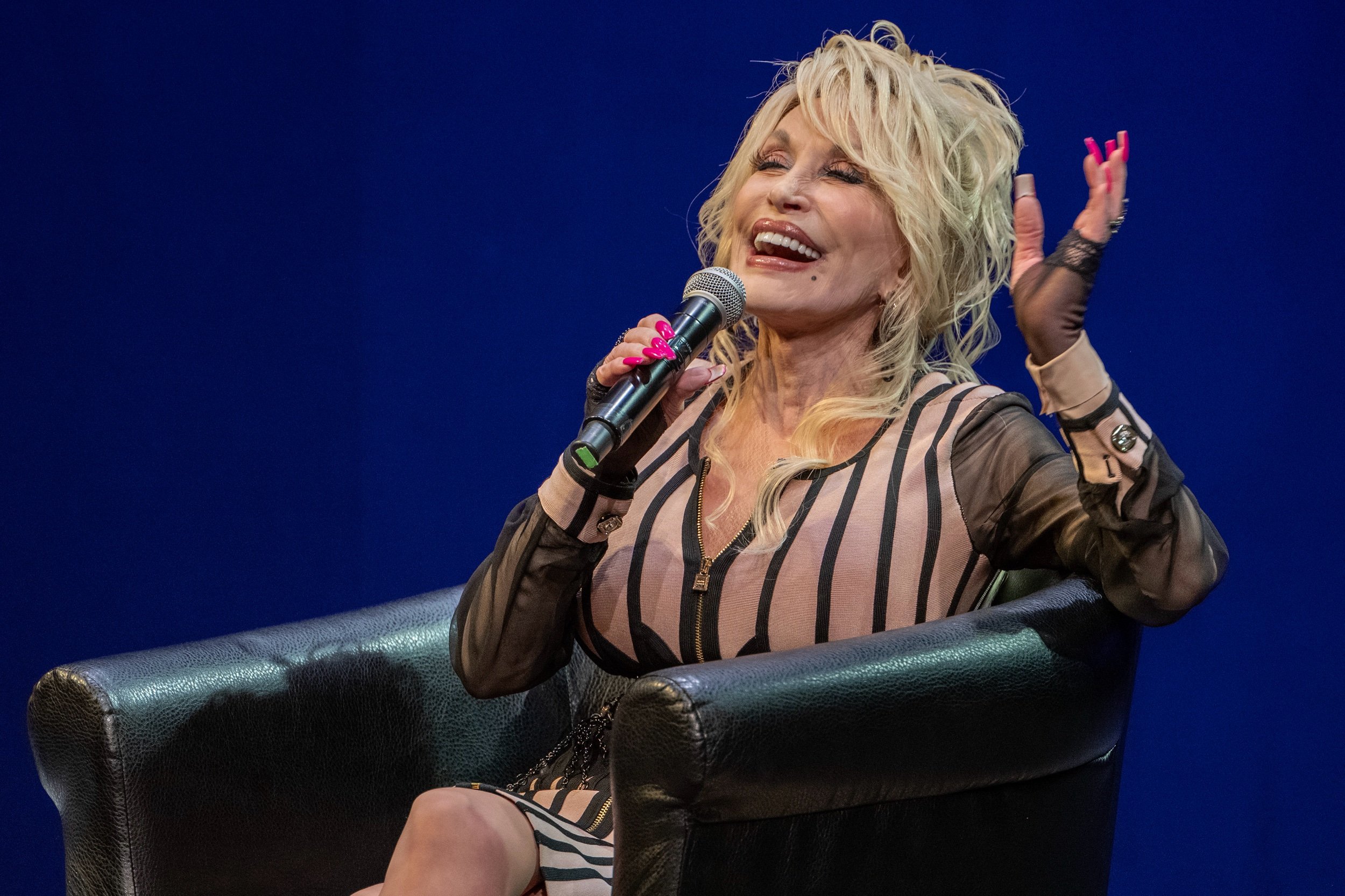 Country singer Dolly Parton speaks about Imagination Library inside the White Theatre at the Jewish Community Center on Monday, Aug. 14, 2023, in Overland Park, Kan. Sharing personal stories, including her father's influence, the renowned country mu