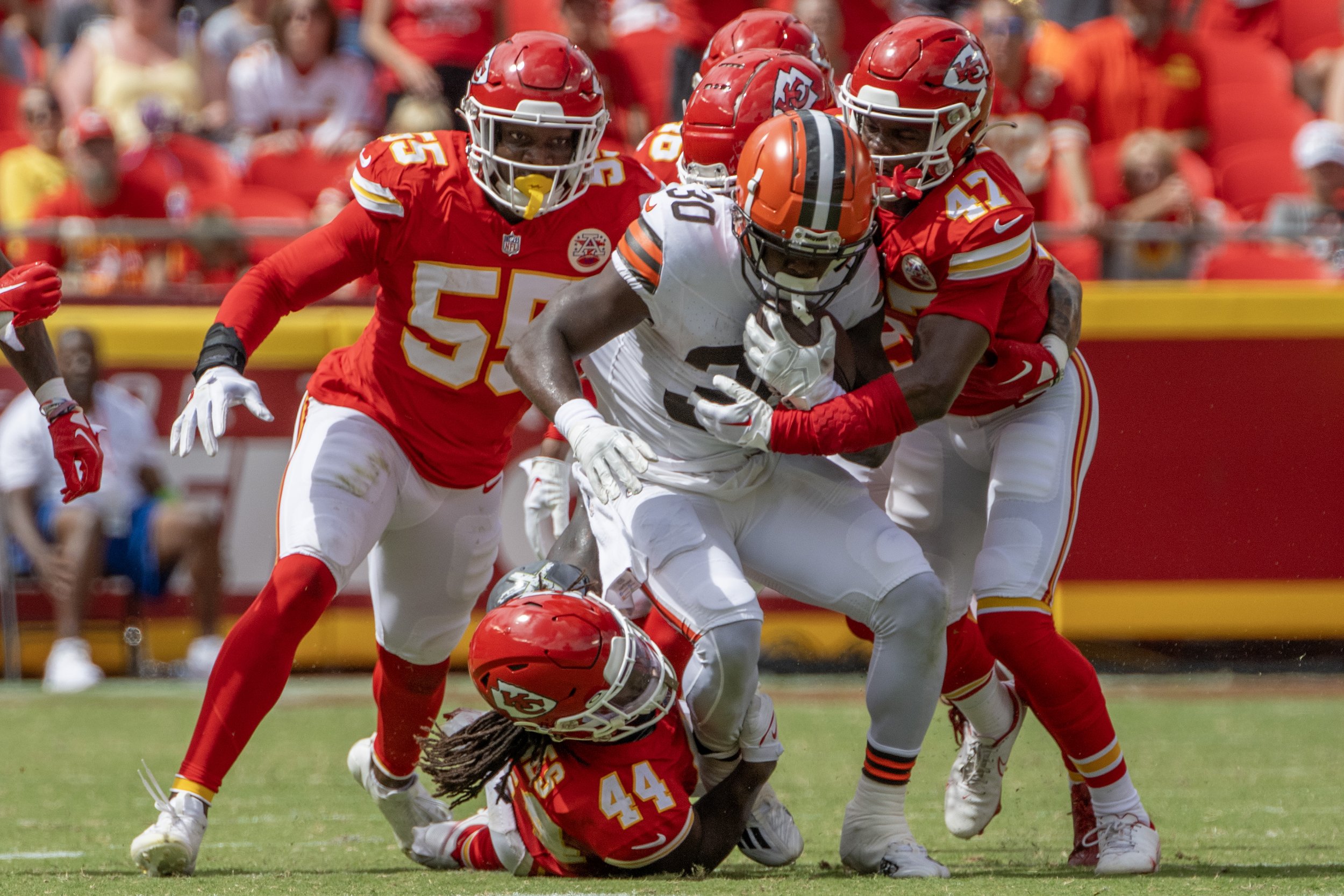  Kansas City Chiefs linebacker Cam Jones (44) and Kansas City Chiefs safety Anthony Cook (47) tackle Cleveland Browns safety Nate Meadors (30) in the fourth quarter during an NFL preseason game at GEHA Field at Arrowhead Stadium on Saturday, Aug. 26,