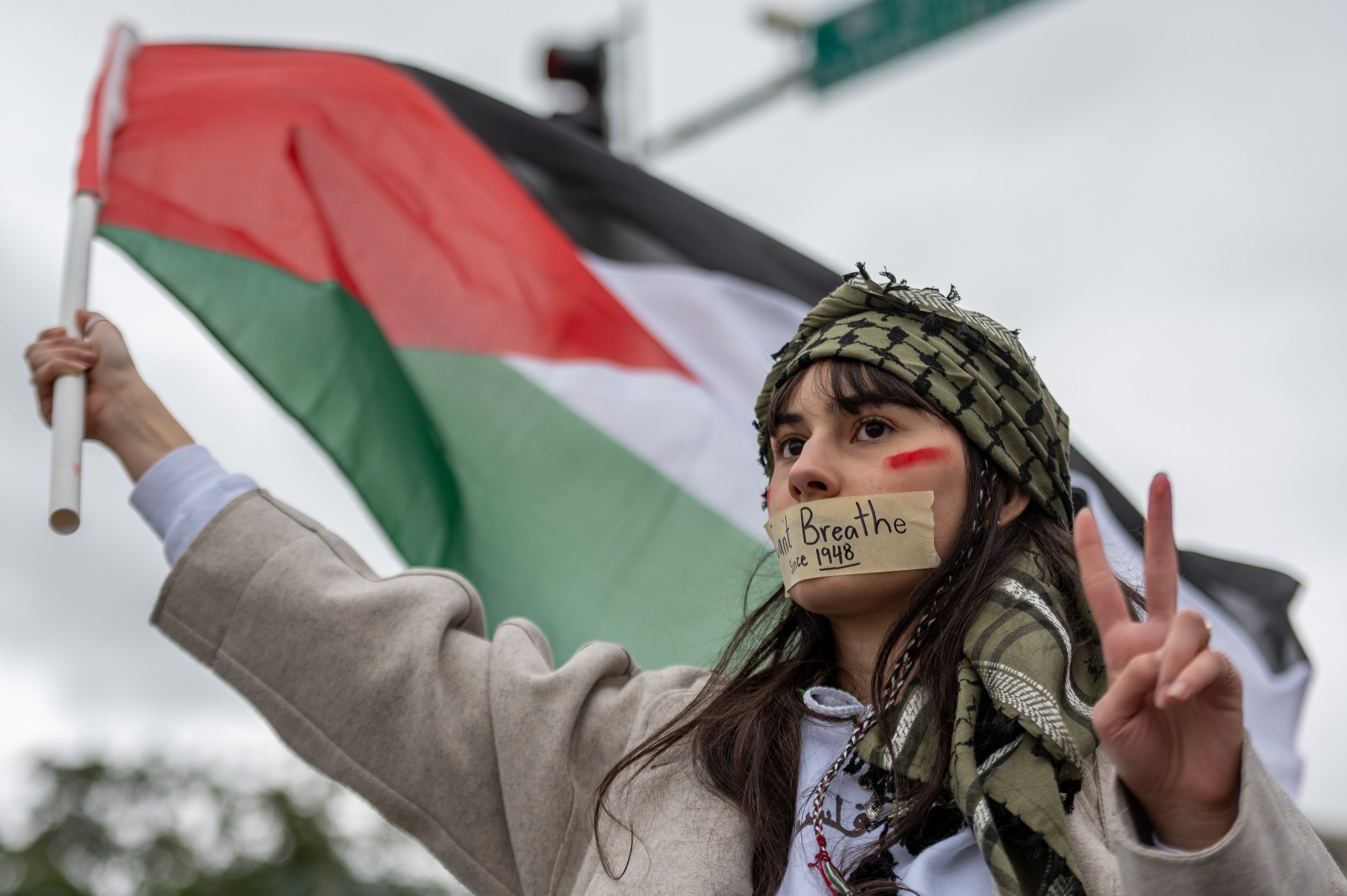  Mayssah Mansi is seen wearing tape around her mouth that reads, 'Can't breathe since 1948,' while attending a rally near the J.C. Nichols Memorial Fountain at the Country Club Plaza on Saturday, Oct. 14, 2023, in Kansas City. The rally was held to r