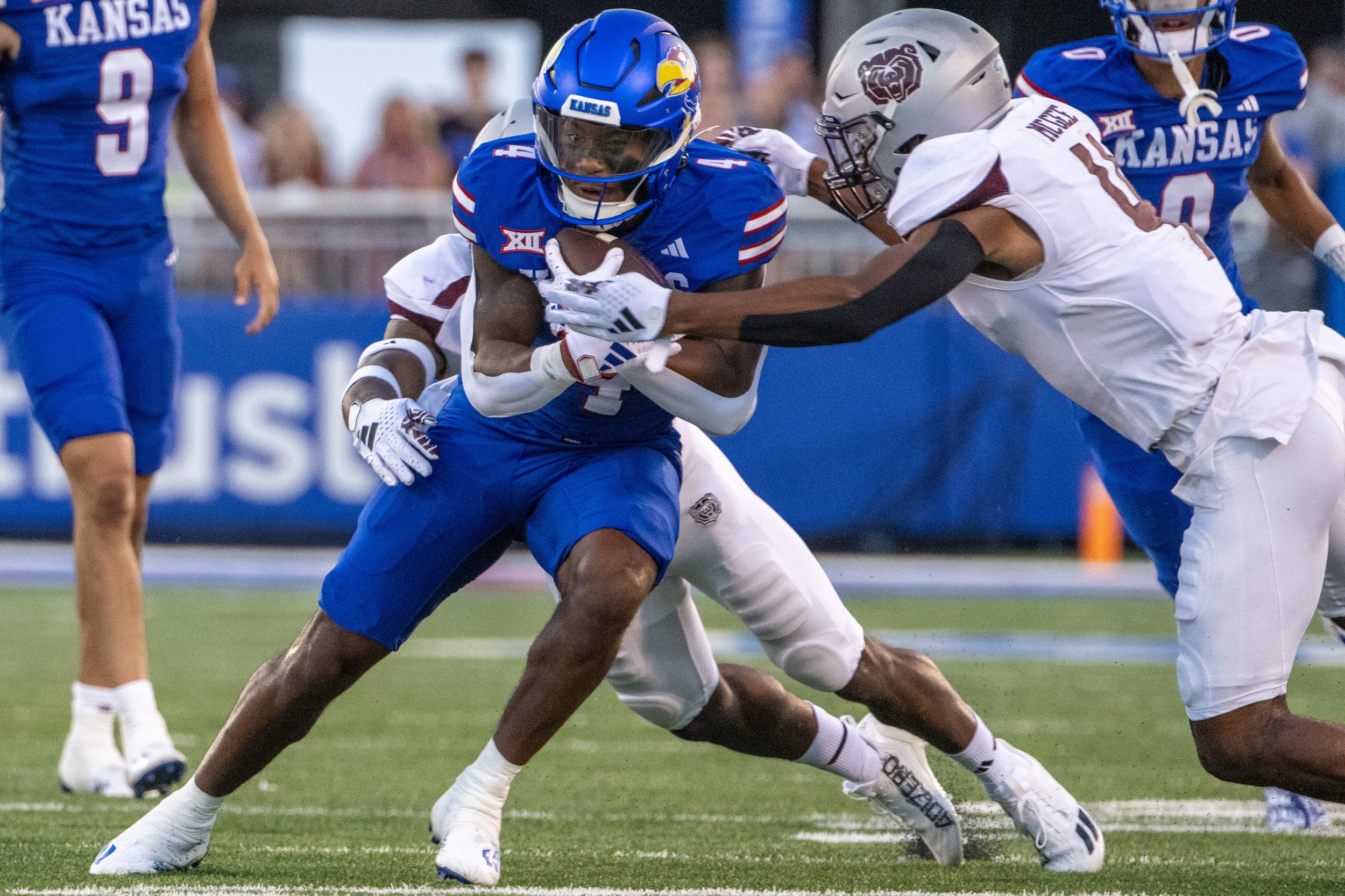   Kansas Jayhawks running back Devin Neal (4) is tackled by Missouri State Bears safety Todric McGee (4) in the second quarter during the season opening game at David Booth Kansas Memorial Stadium on Friday, Sept. 1, 2023, in Lawrence, Kan. 
