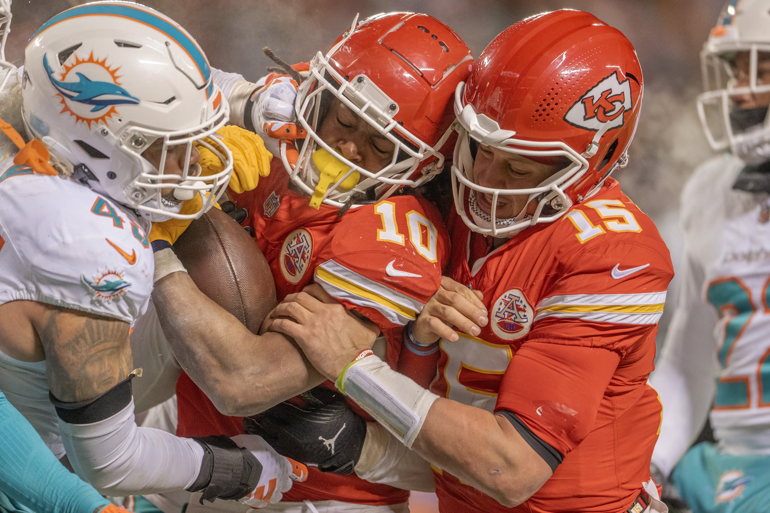  Kansas City Chiefs running back Isiah Pacheco (10) gets a push from quarterback Patrick Mahomes (15) into the end zone for a touchdown in the fourth quarter during an AFC Wild Card game against the Miami Dolphins at GEHA Field at Arrowhead Stadium o
