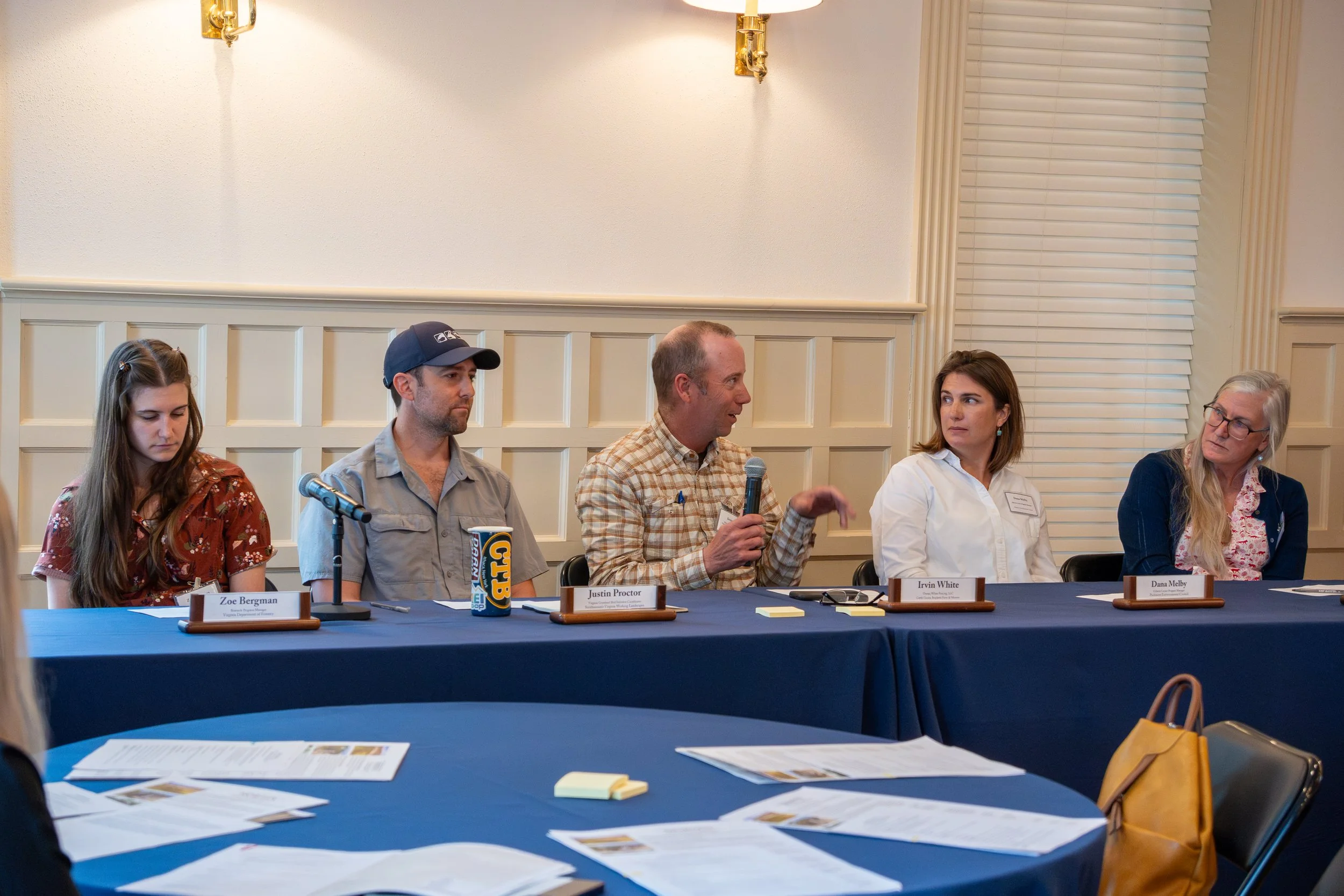 Four participants from the HARVEST workshop panel sit at a table, one speaker has the mic. 