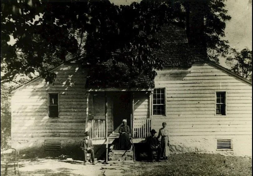 “Old cottage” at Morven (now known as the Claim House), undated but likely during the Edward Buckey Smith ownership era (1879-1906) - the white buliding with front porch is shown with four individuals.