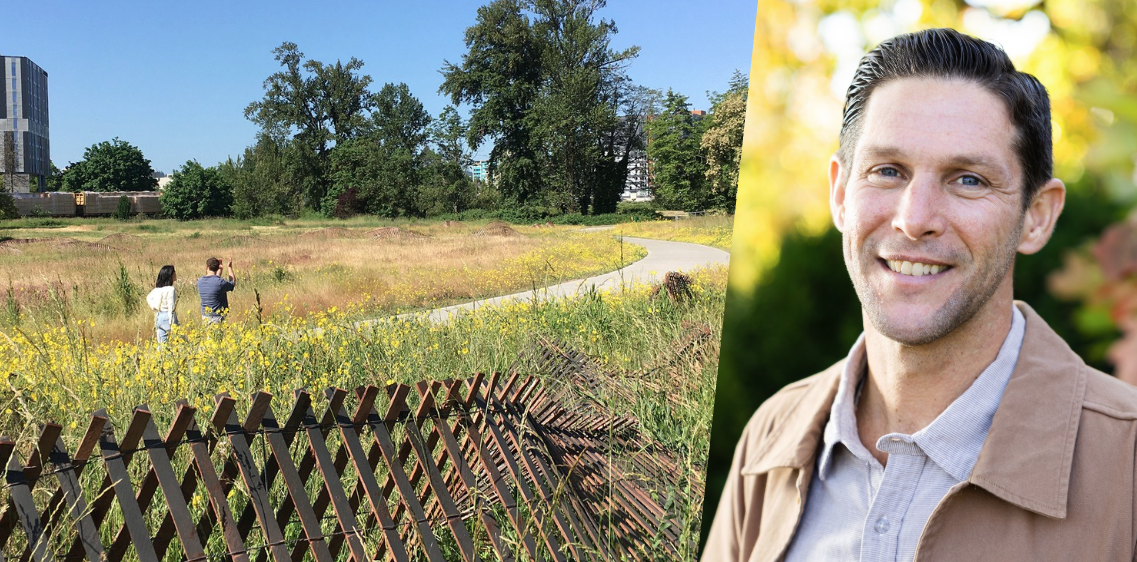 Two people walk along a path lined by grassy meadows.