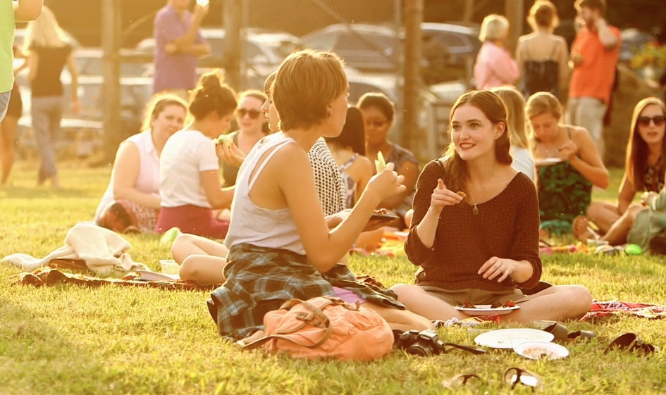 A crowd sits in the grass at the Morven Kitchen garden during the fall Gazpacho in the Garden event.