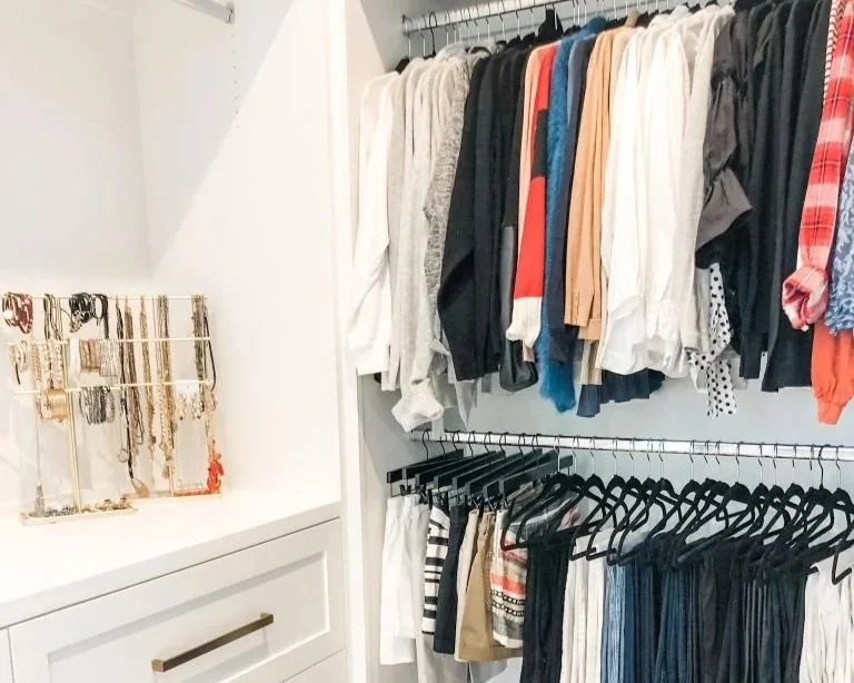 Accessories and clothing arranged in a Preston Hollow primary closet