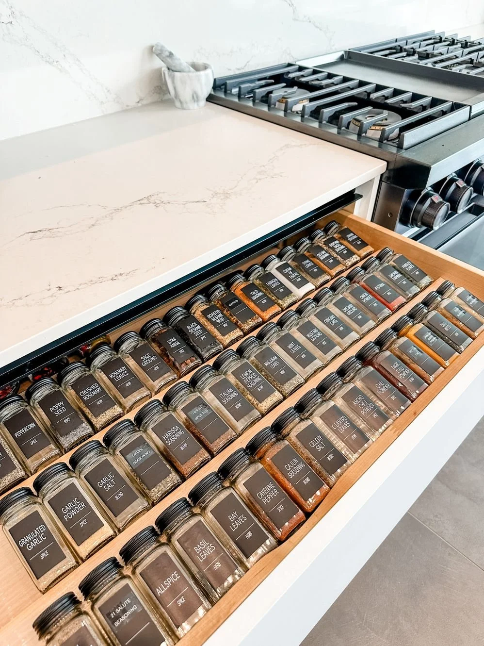 Professional organizer created spice drawer in a Preston Hollow home