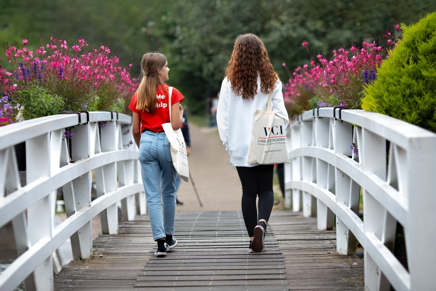 Branding photoshoot for VICI Language Academy, 2 students walking on the bridge carring a VICI bag, captured by branding photographer in Newbury