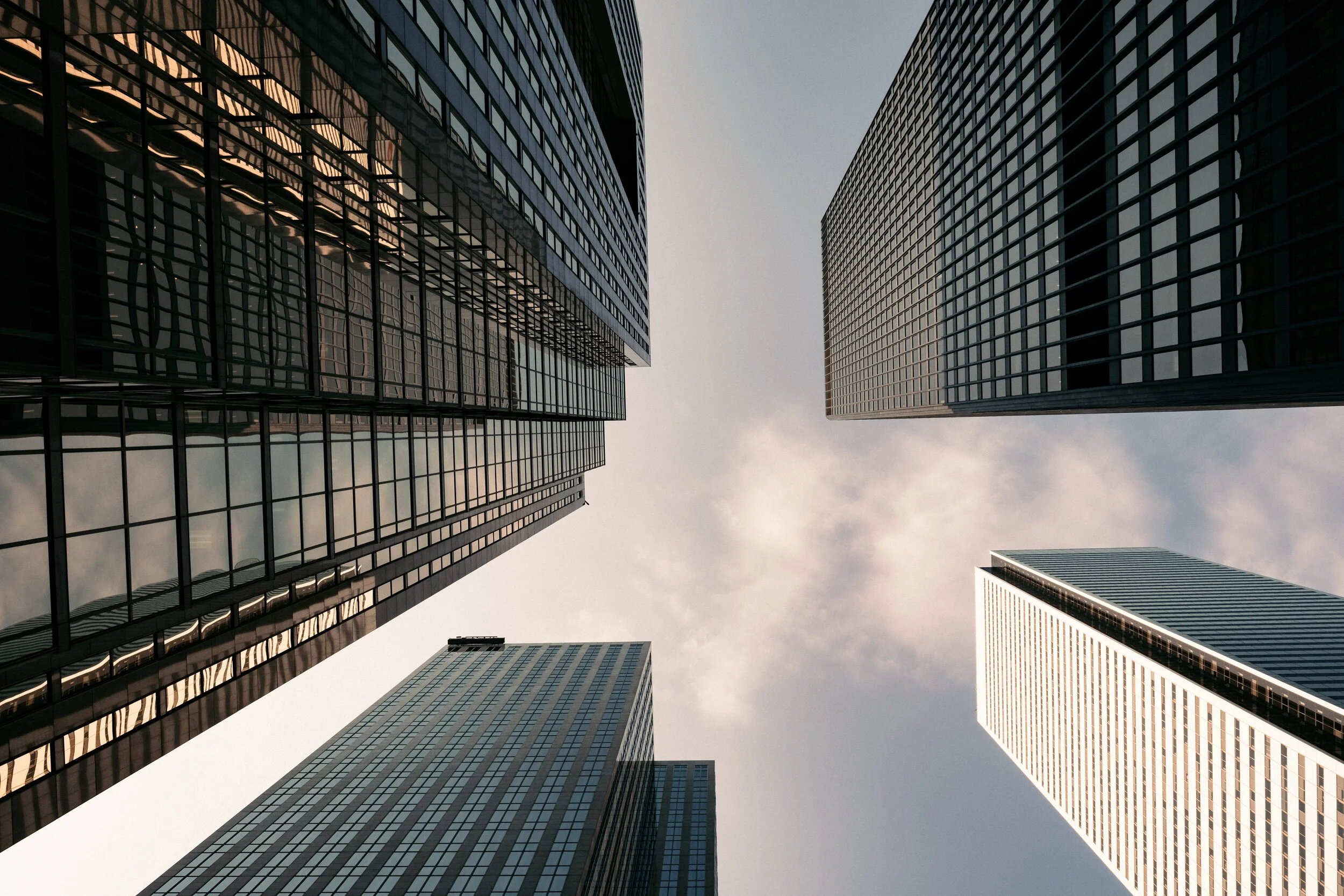four-buildings-from-below-small-clouds.jpg