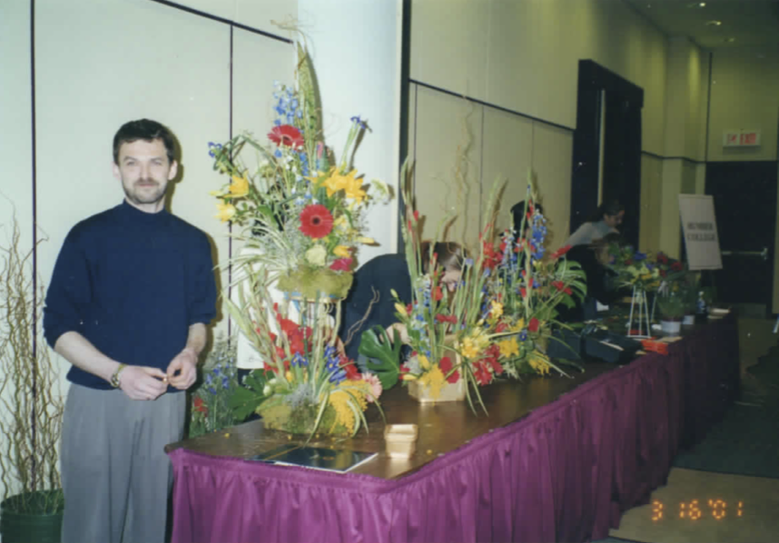  Lubomir standing beside his winning arrangement at the competition table. 