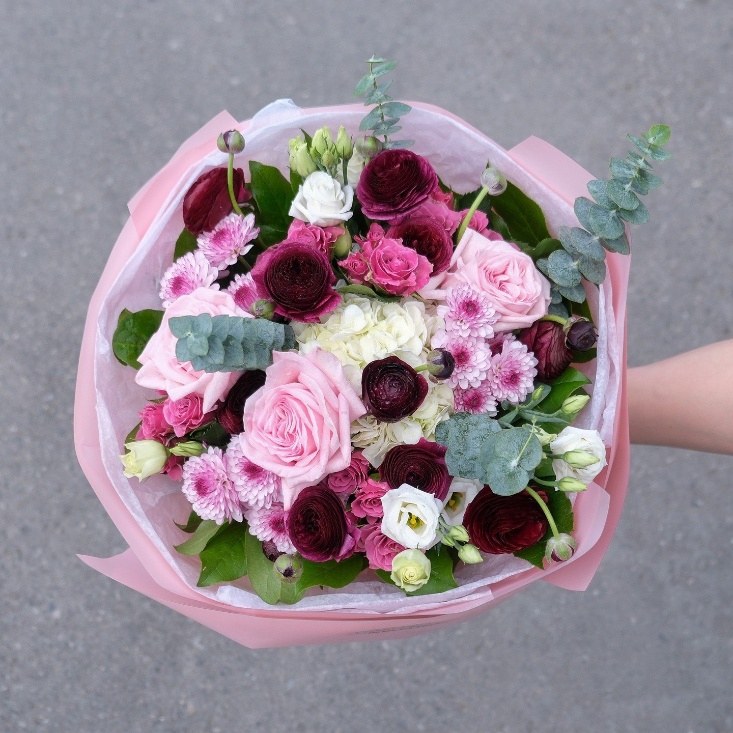 A round hand-tied bouquet featuring pink, white, and burgundy flowers. 

Flowers include hydrangeas, ranunculus, roses, spray chrysanthemums, lisianthus and spray roses.

#mississaugaflorist #mississaugaflowers #gtaflorist #flowers #flowerfantasy #fl