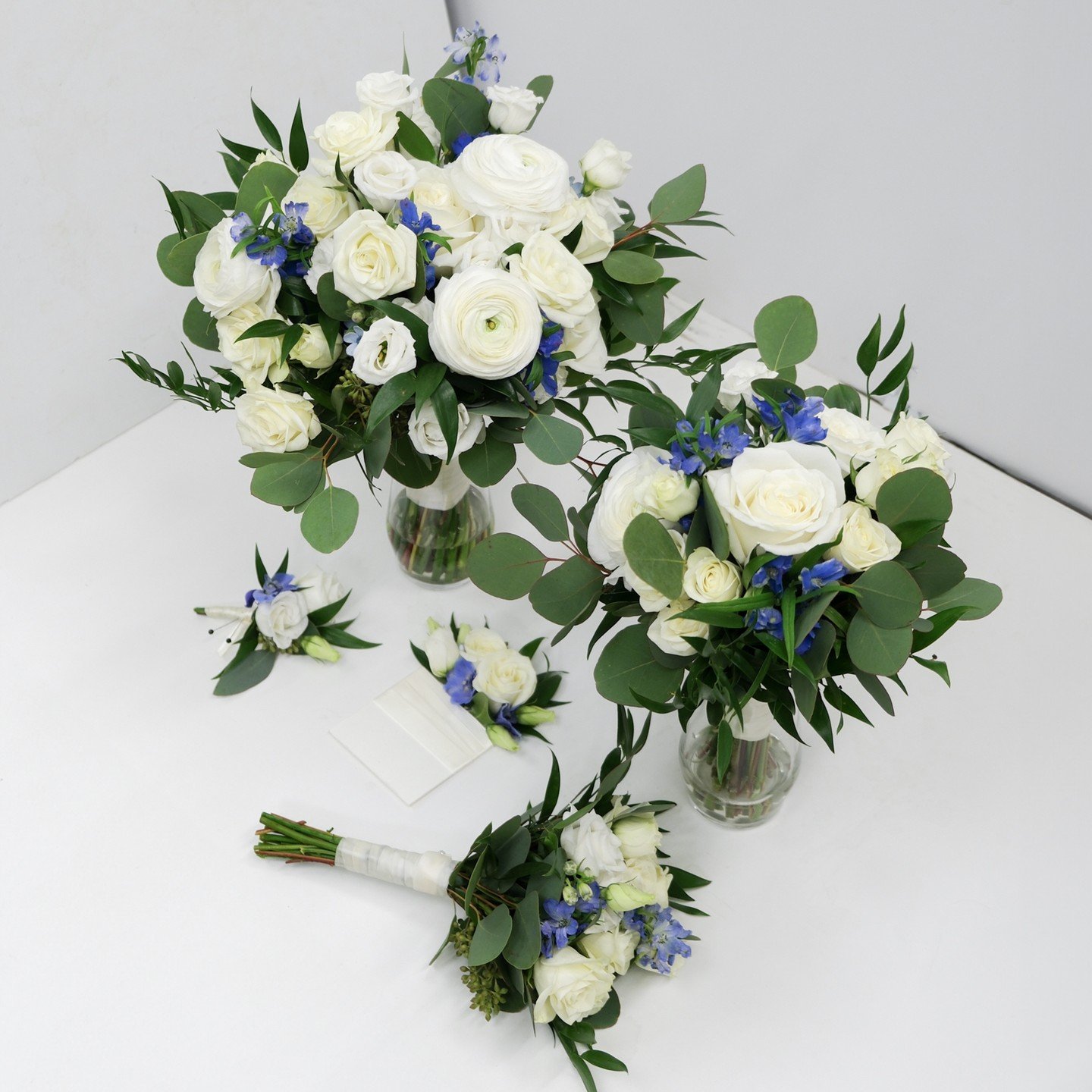 A white and blue wedding party set featuring white ranunculus, blue spray delphinium, white lisianthus and white roses. 

#mississaugaflorist #mississaugaflowers #gtaflorist #flowers #flowershop #flowerfantasy #florist #ukrainianflorist #weddingflowe