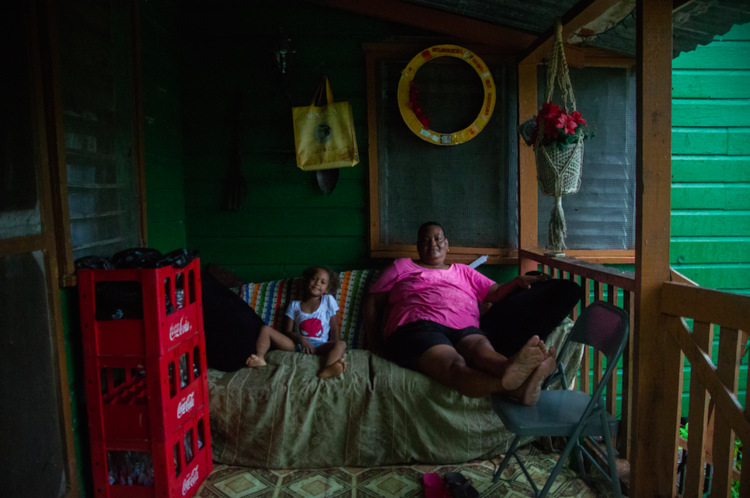 Dory sits with her Grandmother Dorla, Vice President of the Community Baboon Sanctuary.